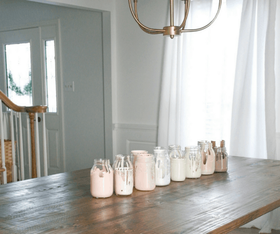 white room with wood table and painted jars