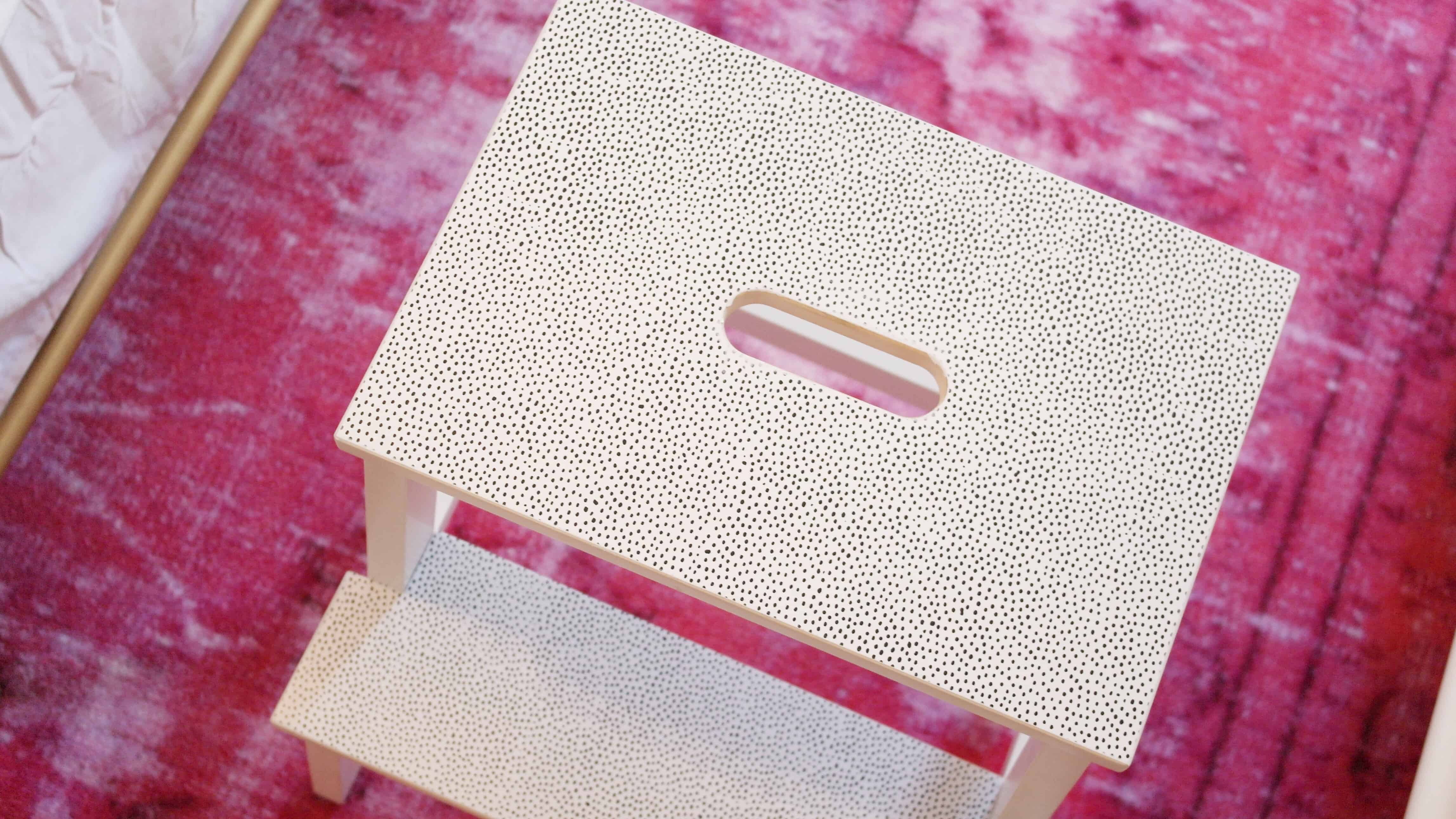 white Ikea stool on pink rug