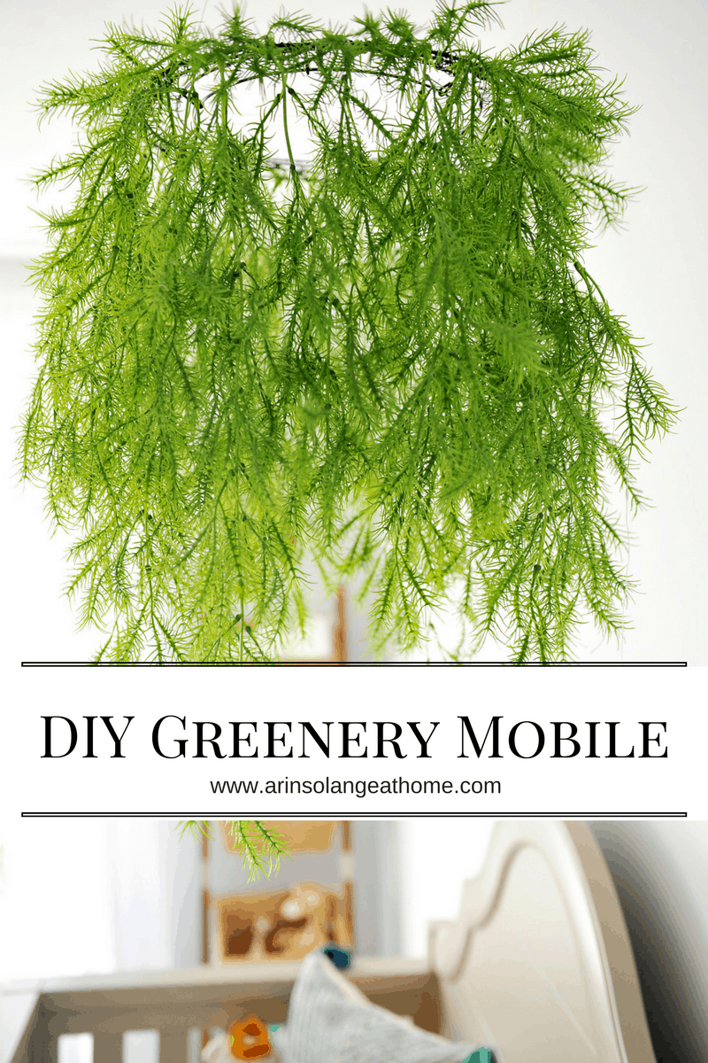 faux greenery mobile over crib with text overlay