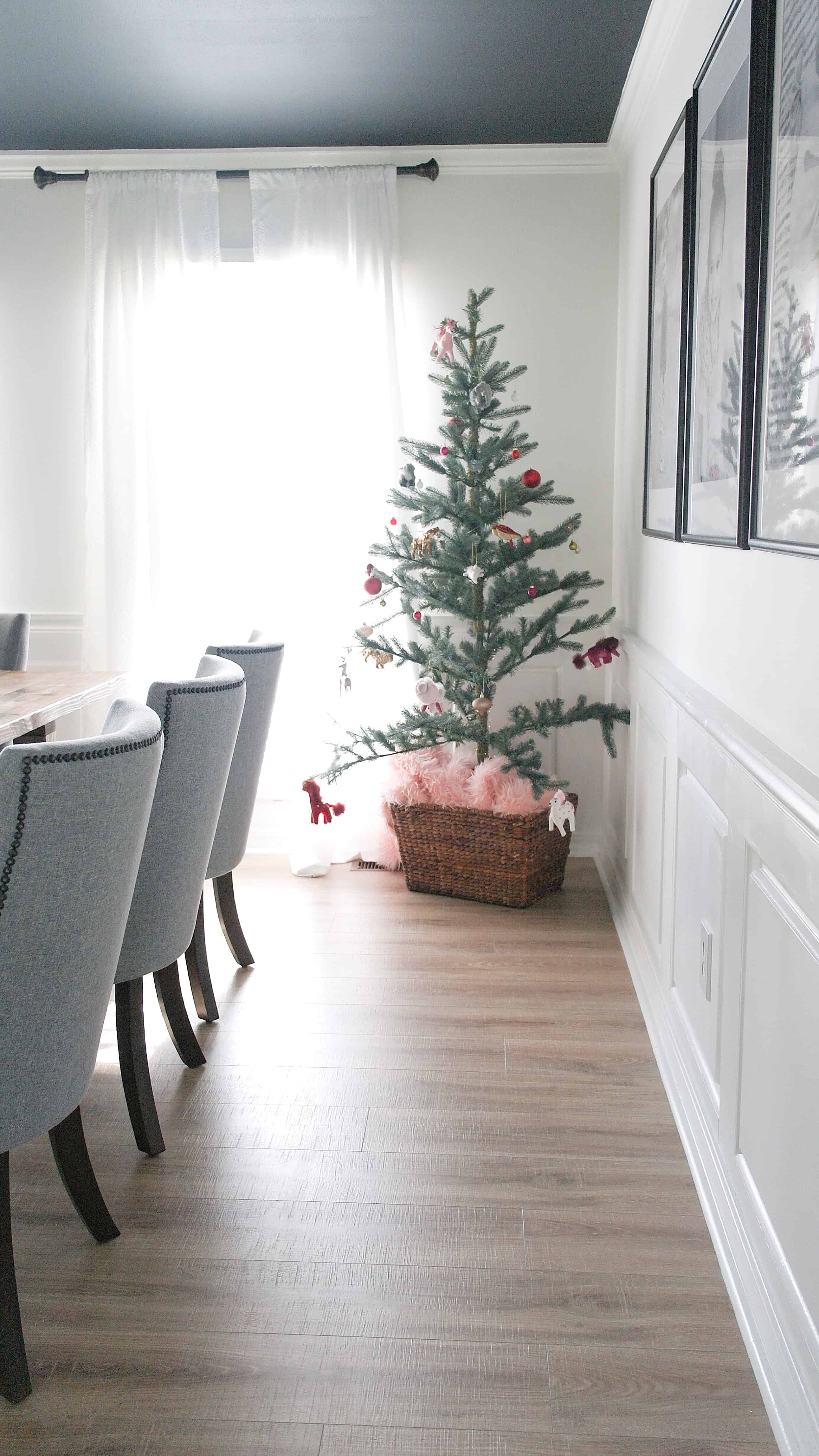 small Christmas tree with pink skirt in basket