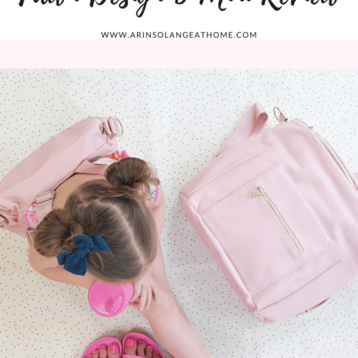 little girl with pink fawn design bag and blush fawn design diaper bag