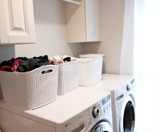 white washer and dryer with white laundry baskets