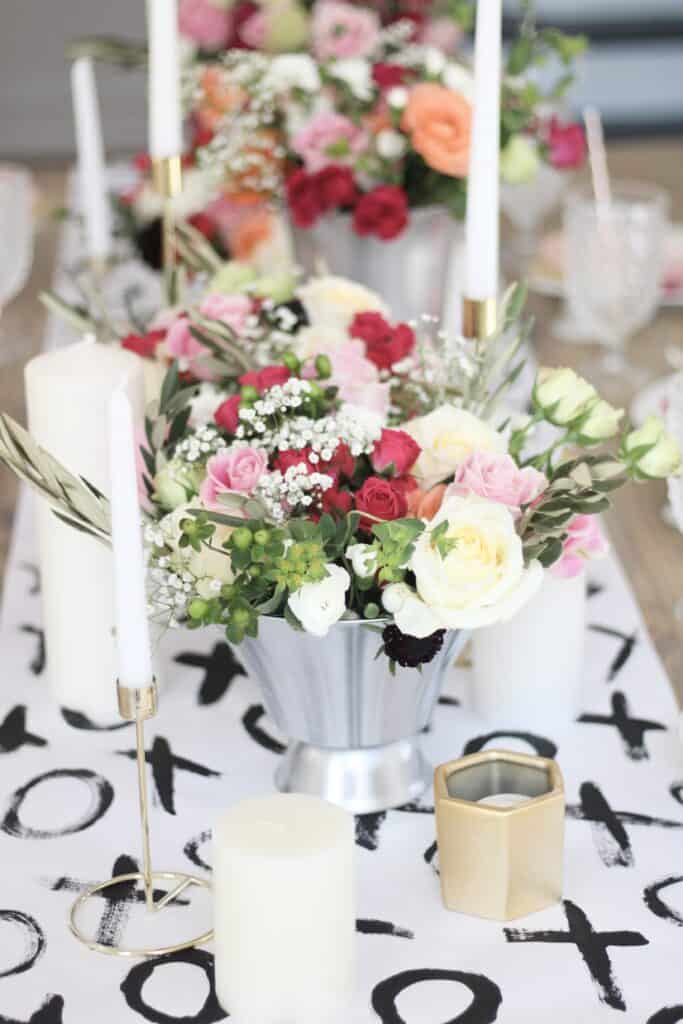 xoxo table runner with floral arrangements 