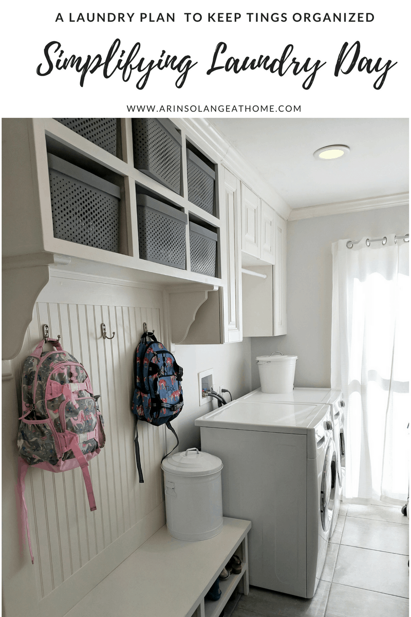 laundry room with pottery barn backpacks and white bins | Simplifying Laundry Day 