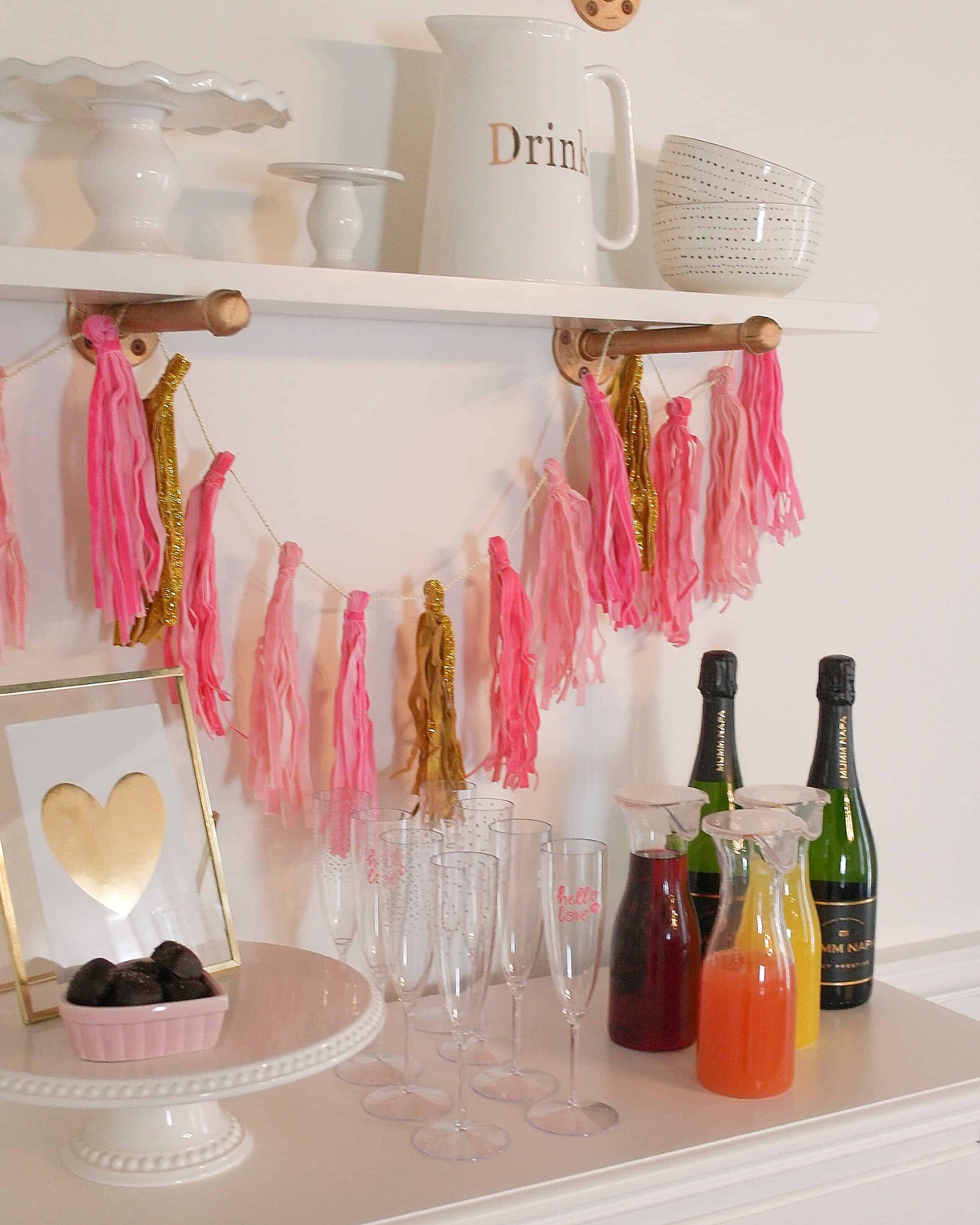 pink banner, juice, champagne on white chest of drawers | Valentine's Day Party 