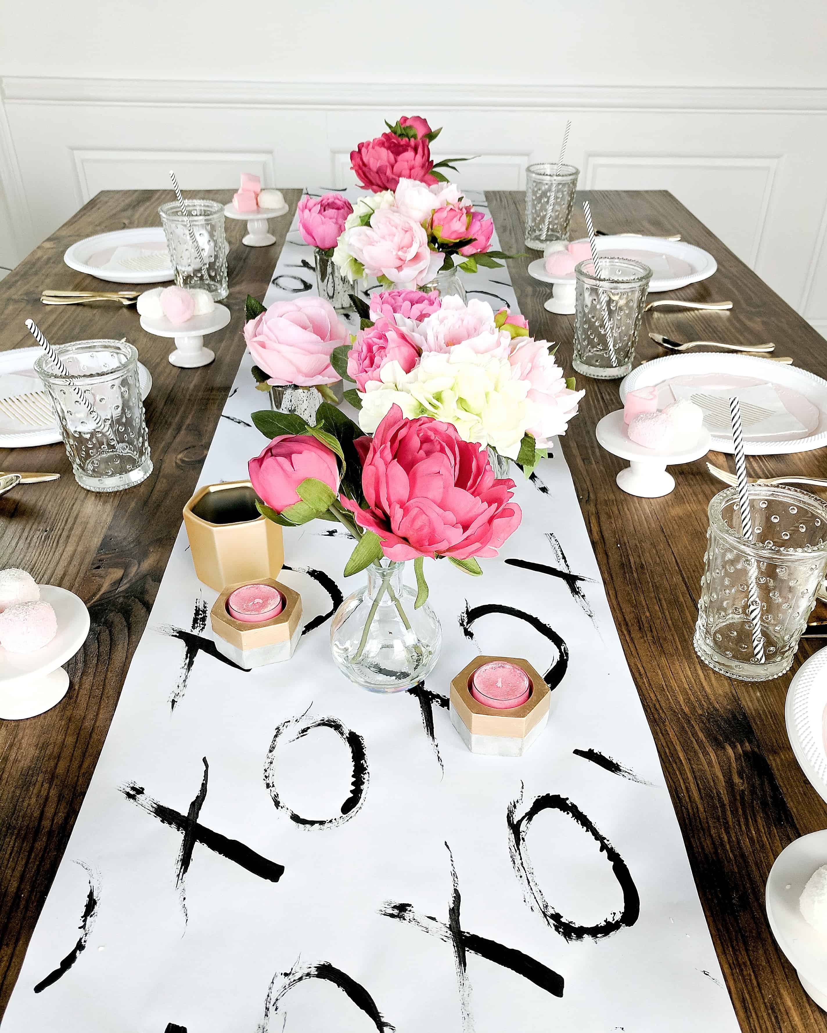 Table setting with wood table black and white table runner and floral and gold accents - Valentine's Day Party 