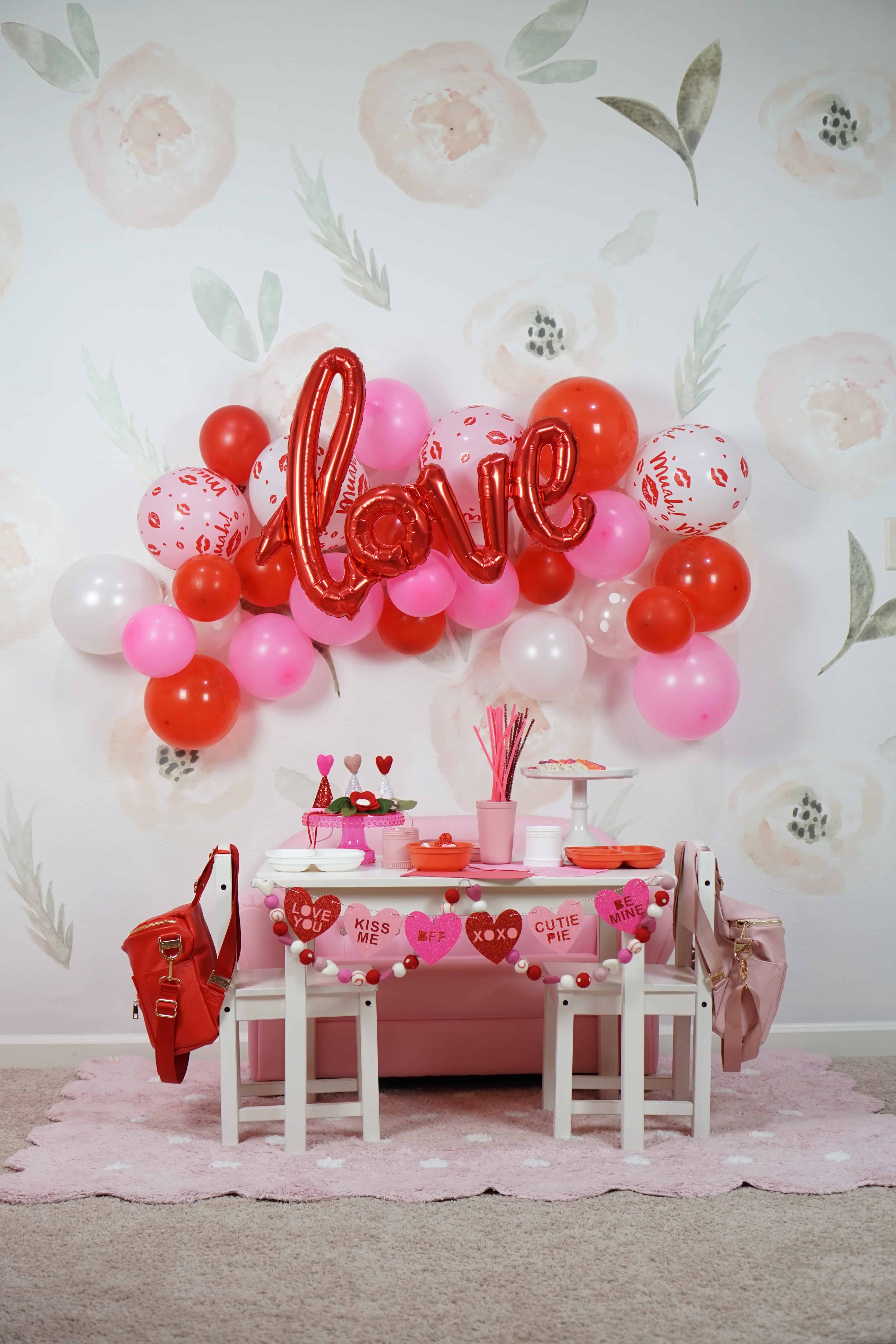 pink and red balloons and table scape with toddlers