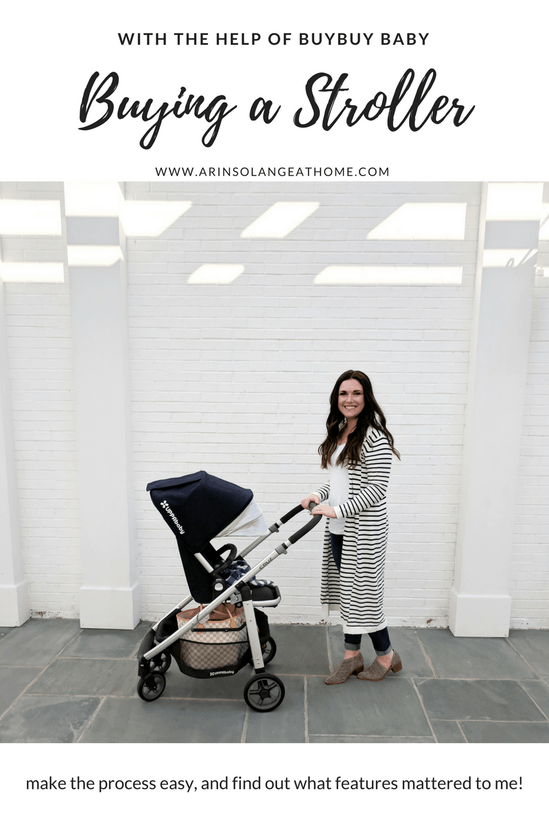 mom pushing an UPPAbaby cruz stroller by white wall | Buying a Stroller 