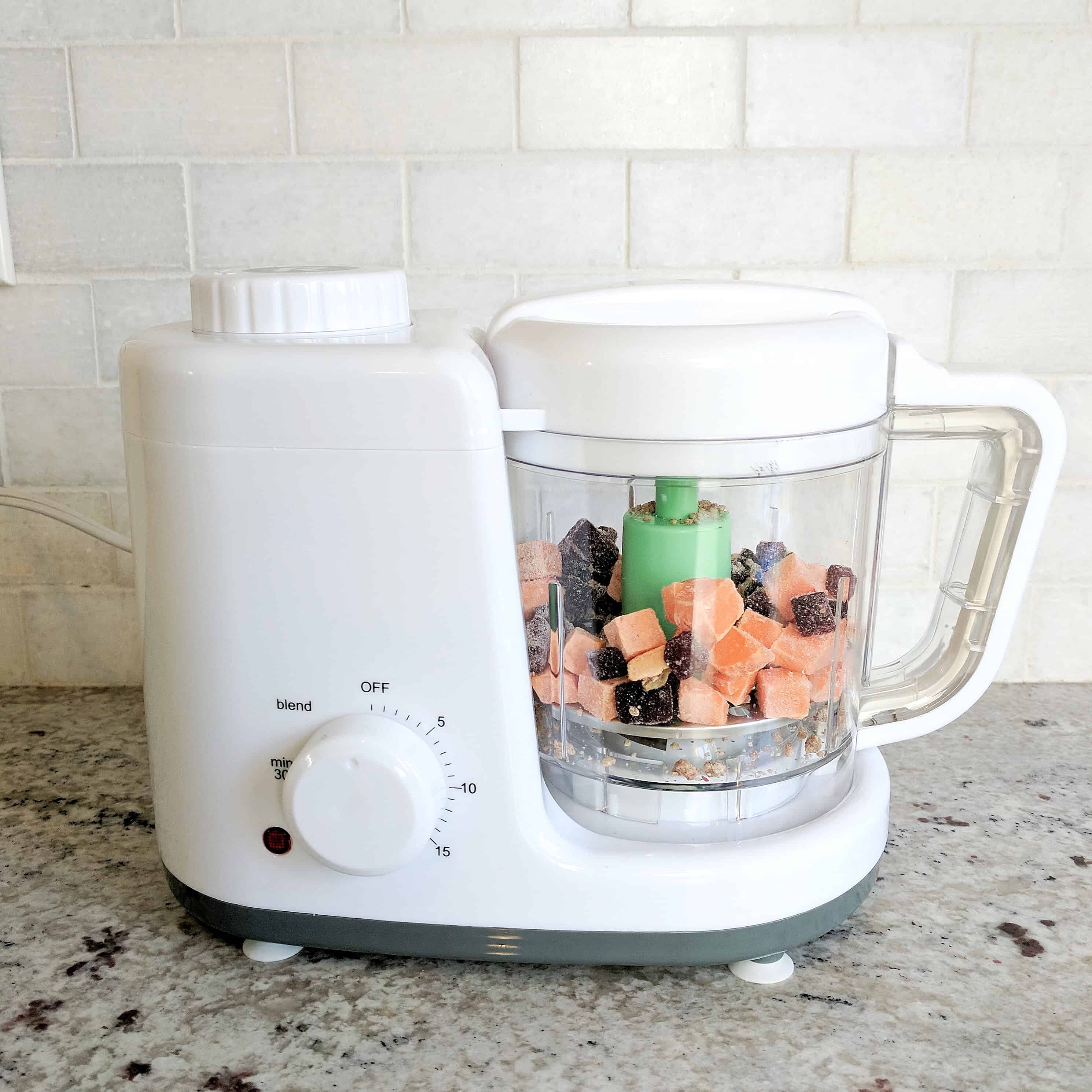 Baby food maker with baby food in it on kitchen counter