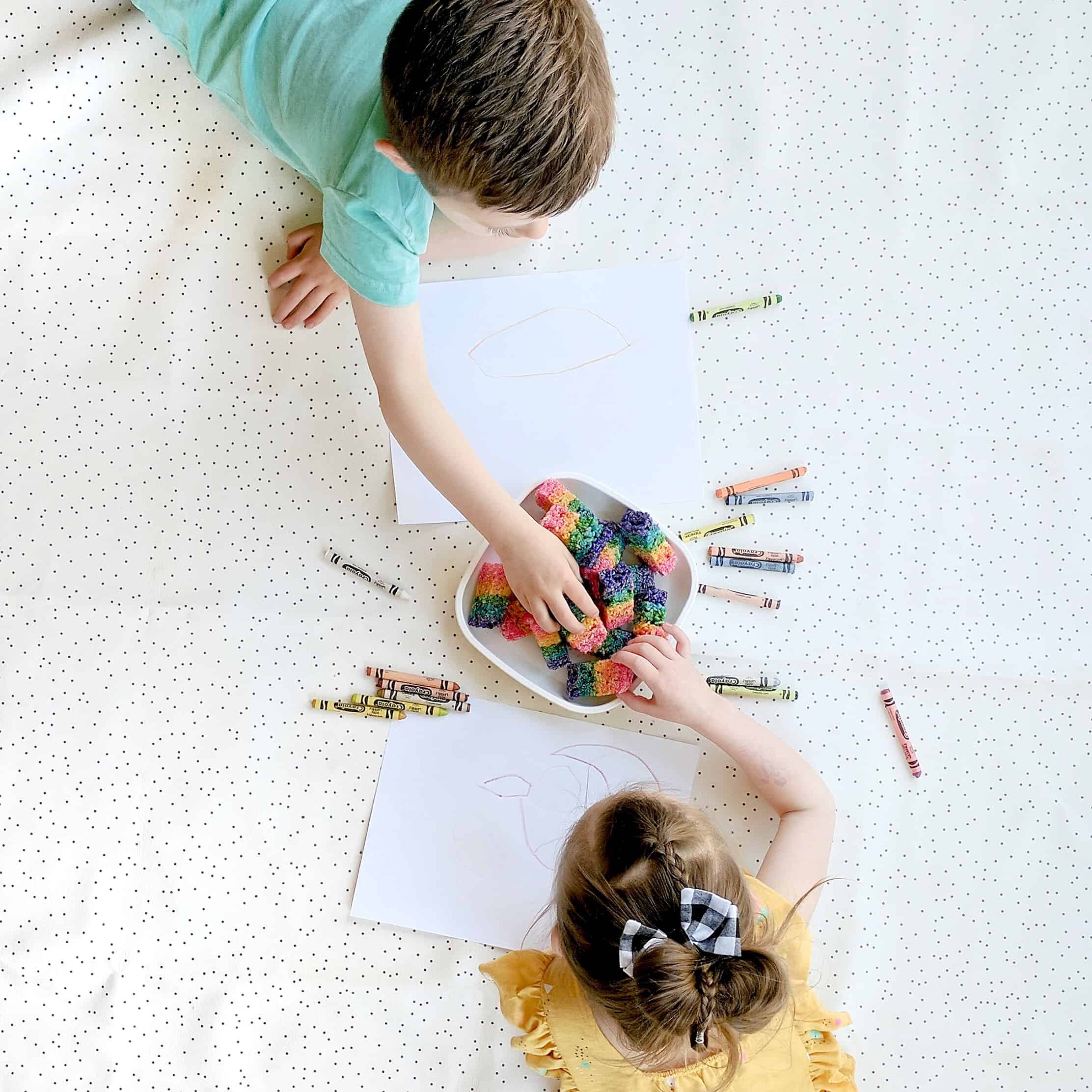 kids playing and coloring on white mat