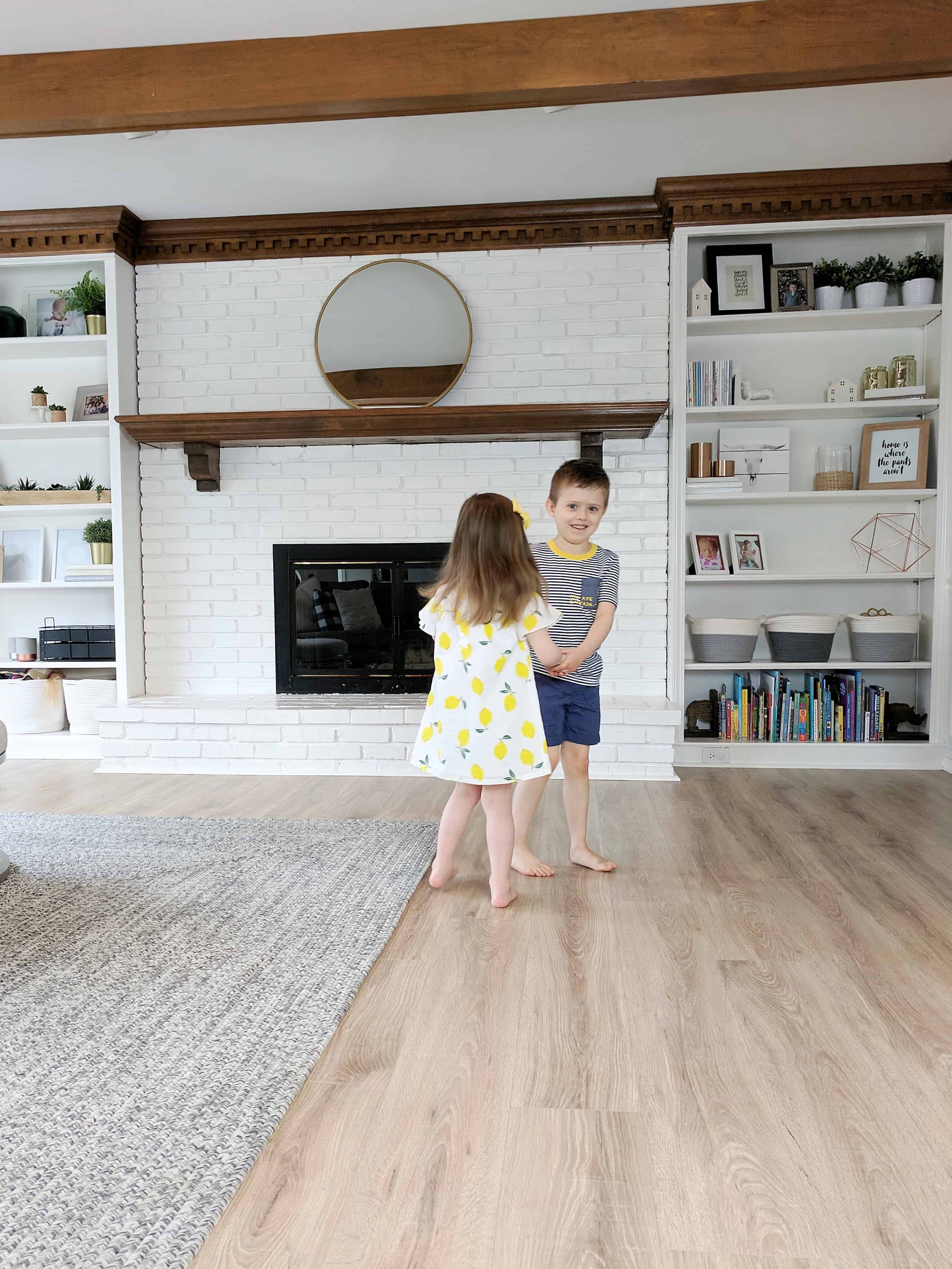 Kids playing ring around the rosey in the living room