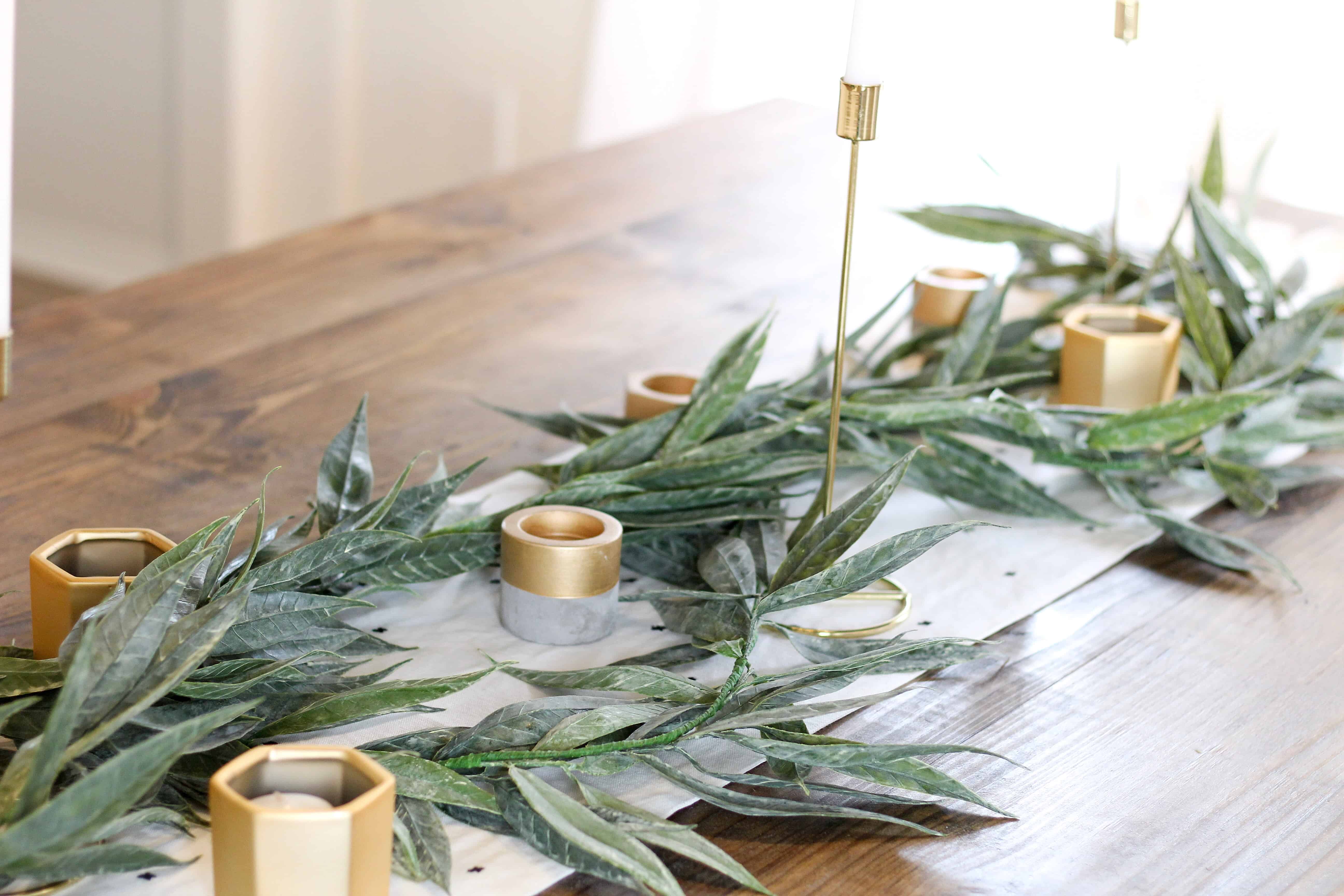 Table with greenery and gold accents | Modern Dining Room with Dark Ceiling