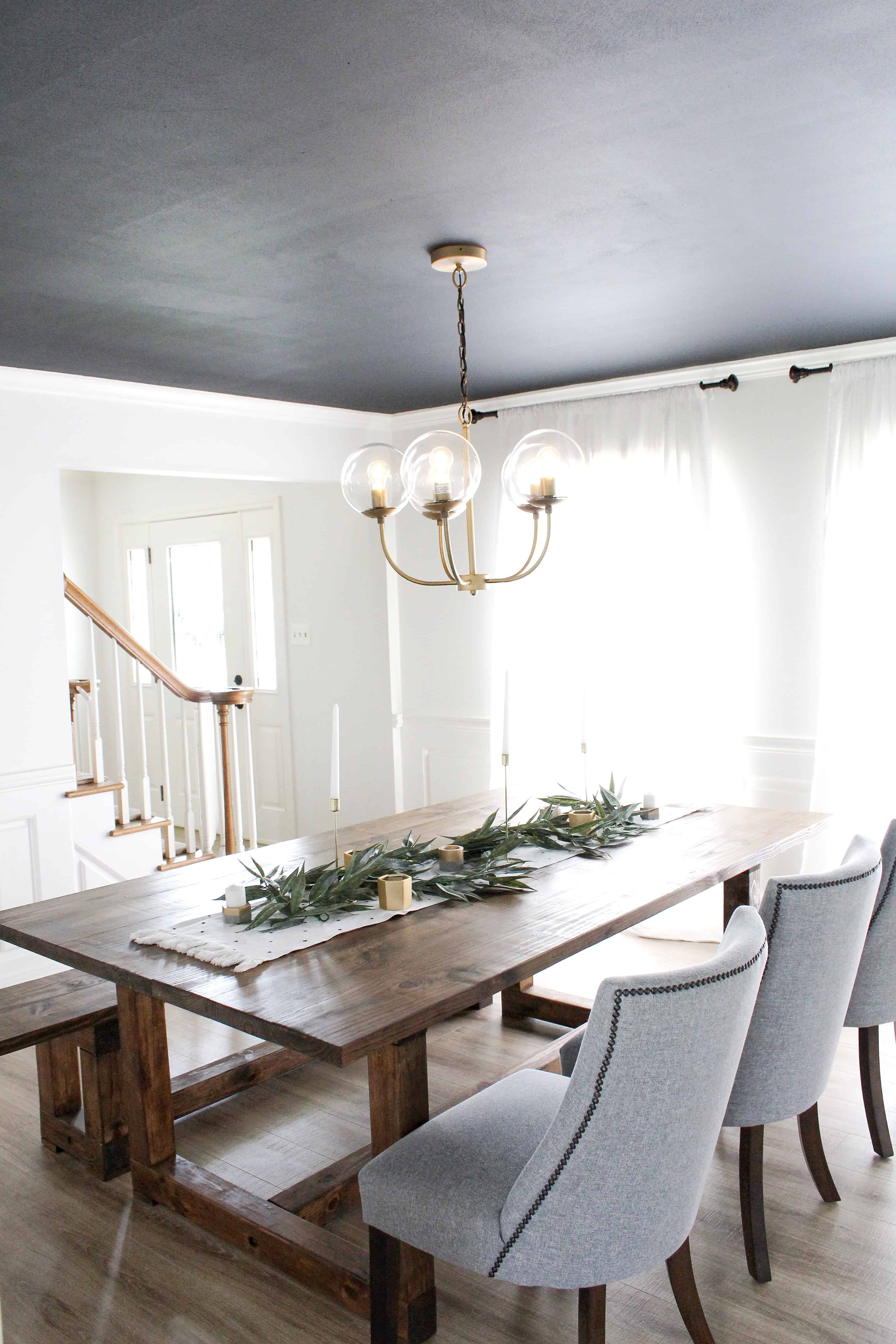 dining room with dark ceiling and large black and white prints | Modern Dining Room with Dark Ceiling