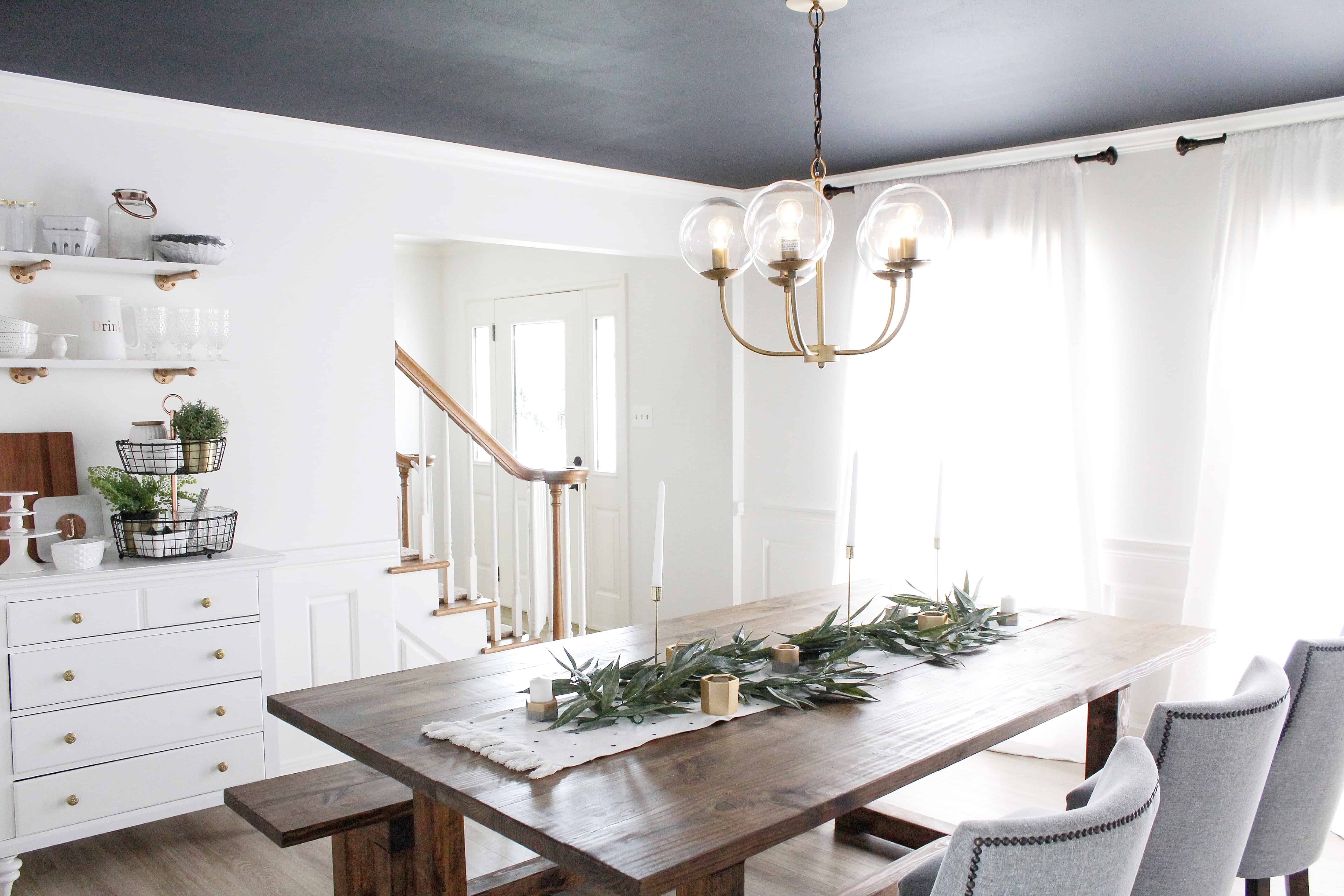 dining room with dark ceiling and large black and white prints | Modern Dining Room with Dark Ceiling