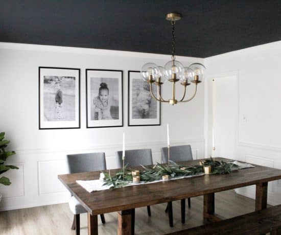 dining room with dark ceiling and large black and white prints