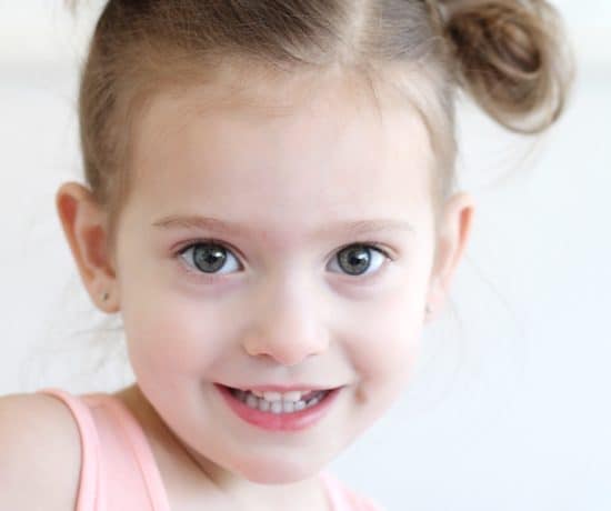 toddler girl with pigtail buns