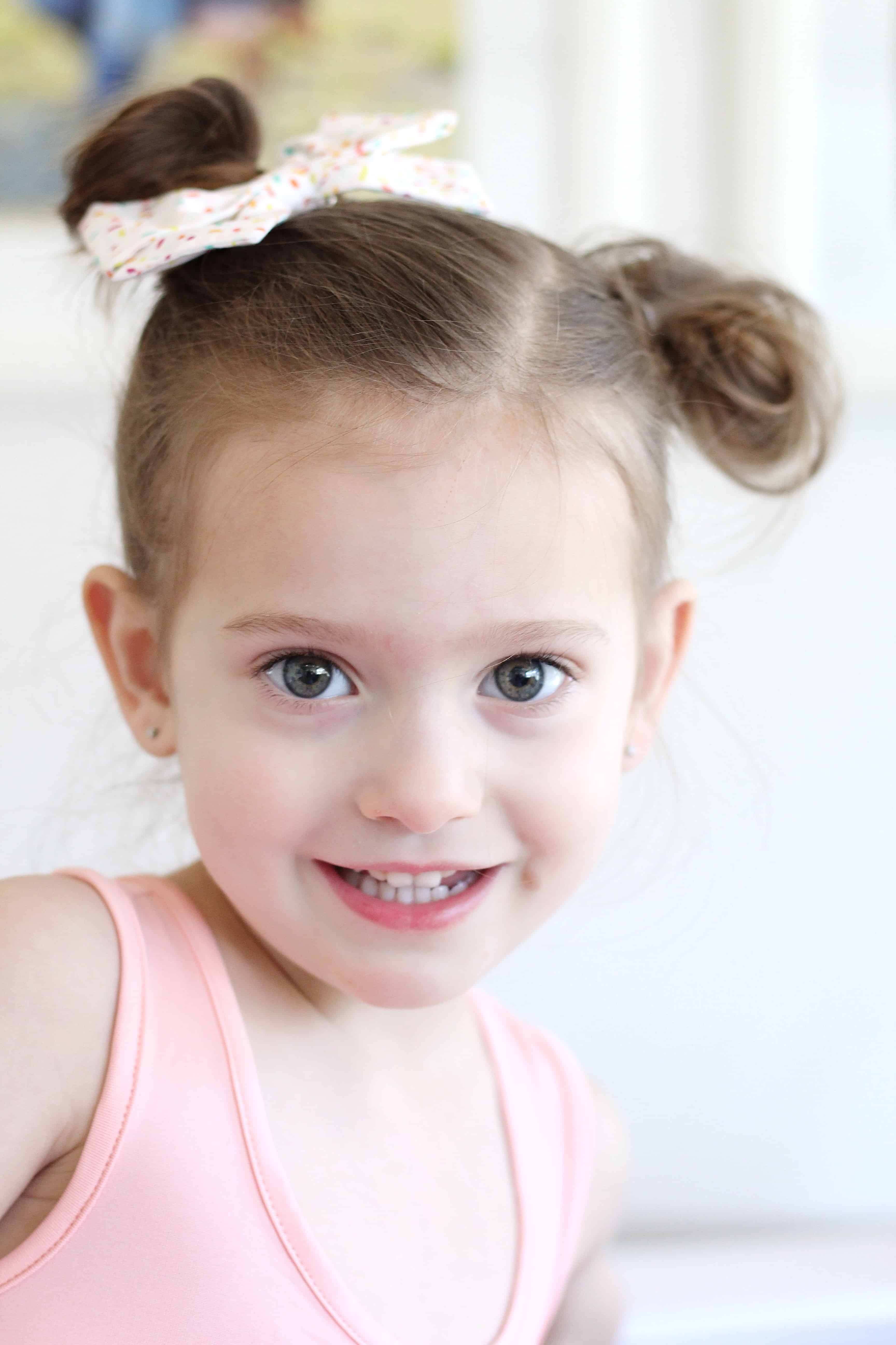 toddler girl with pigtail buns