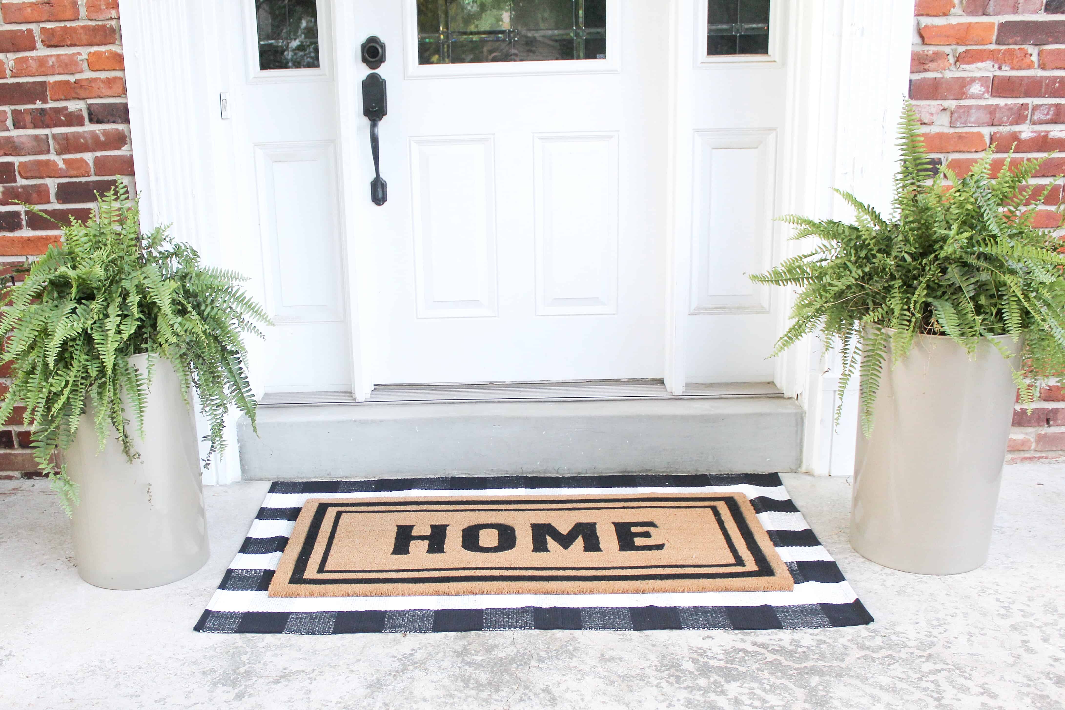 front patio with layered rugs | Trash Can Planter Hack 