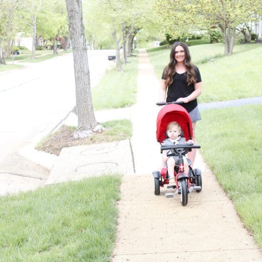 mom pushing Bentley trike on sidewalk