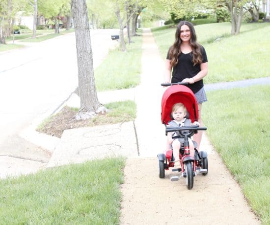 mom pushing Bentley trike on sidewalk