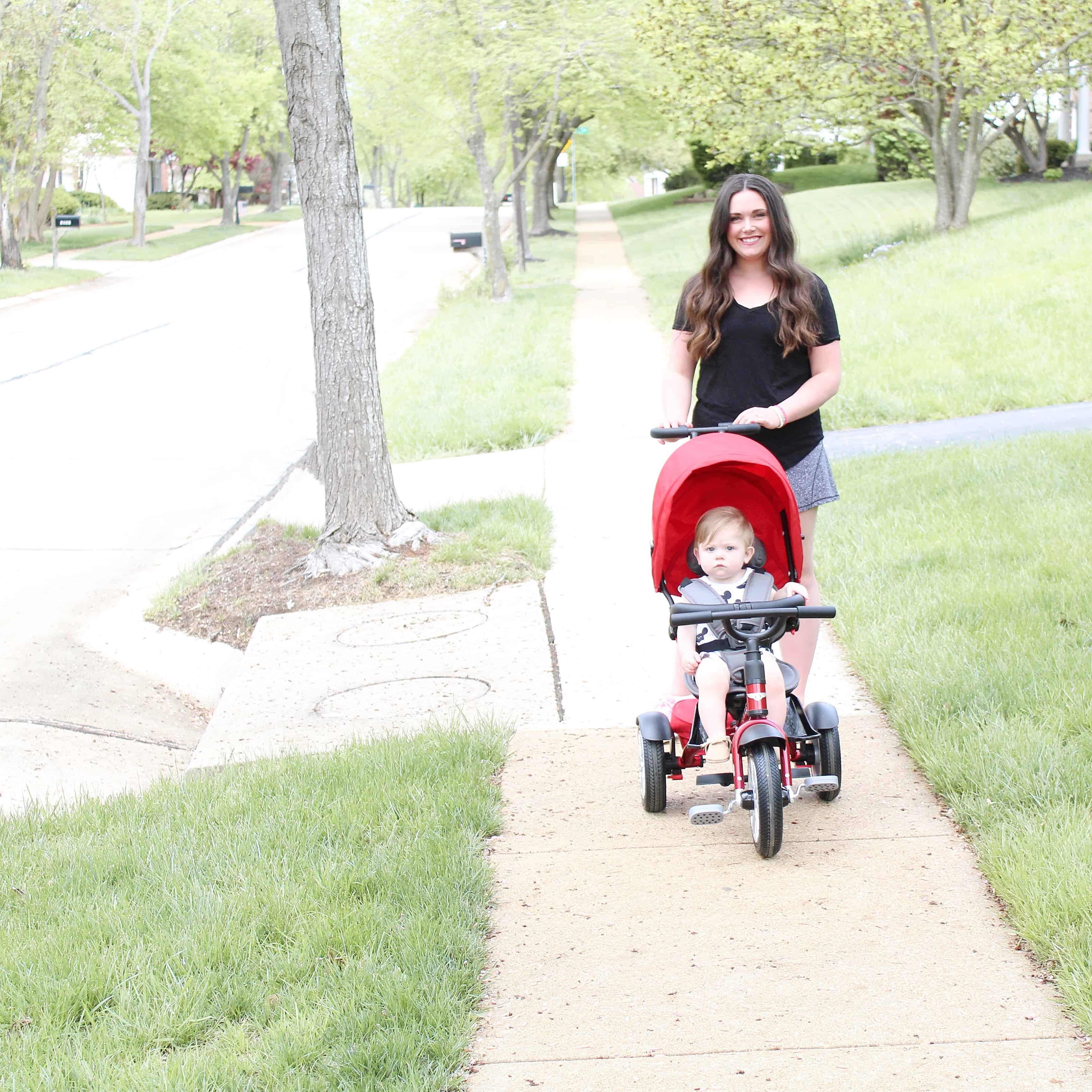 mom pushing Bentley trike on sidewalk | One Year Old Boy Gift Guide