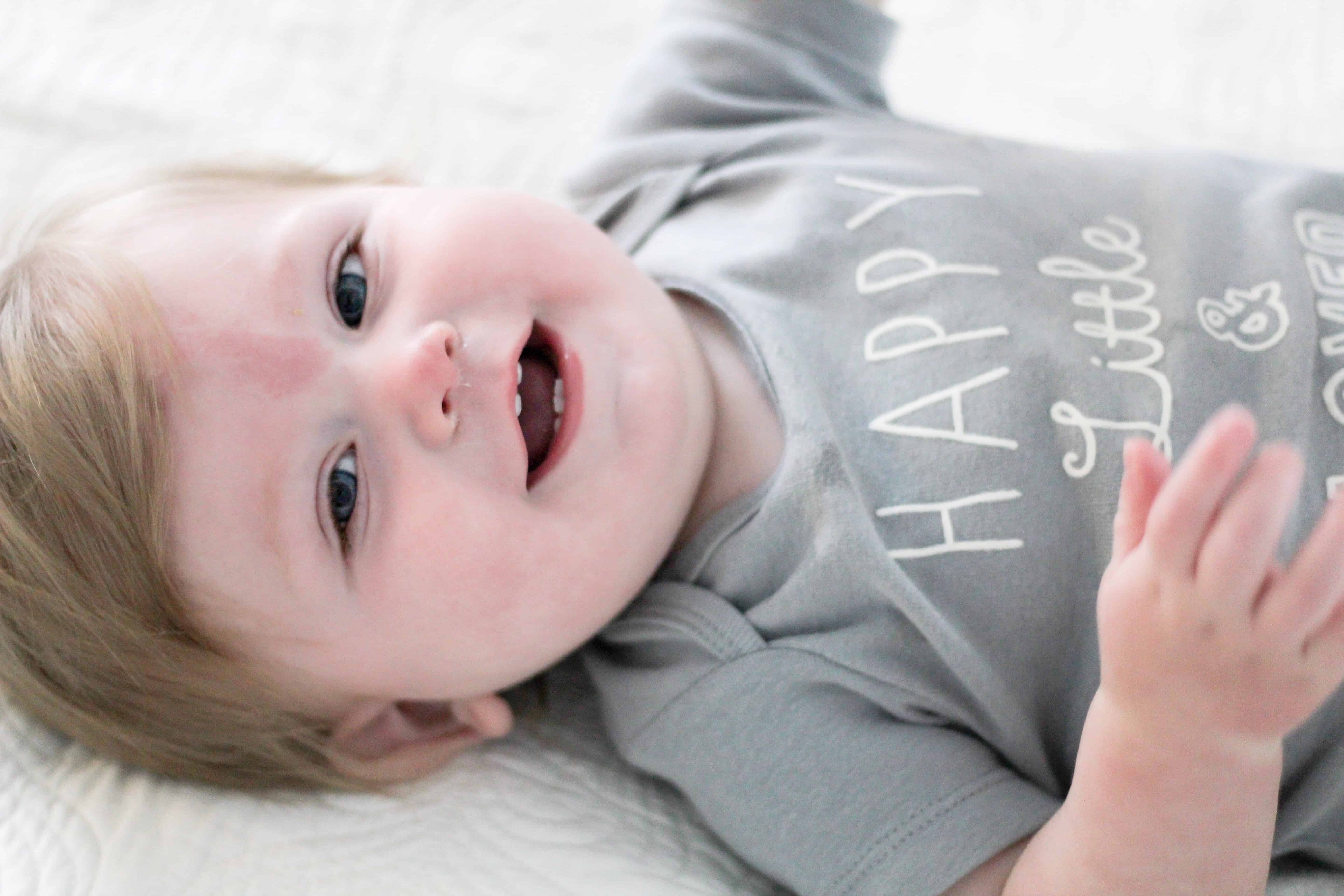 baby laying in grey shirt