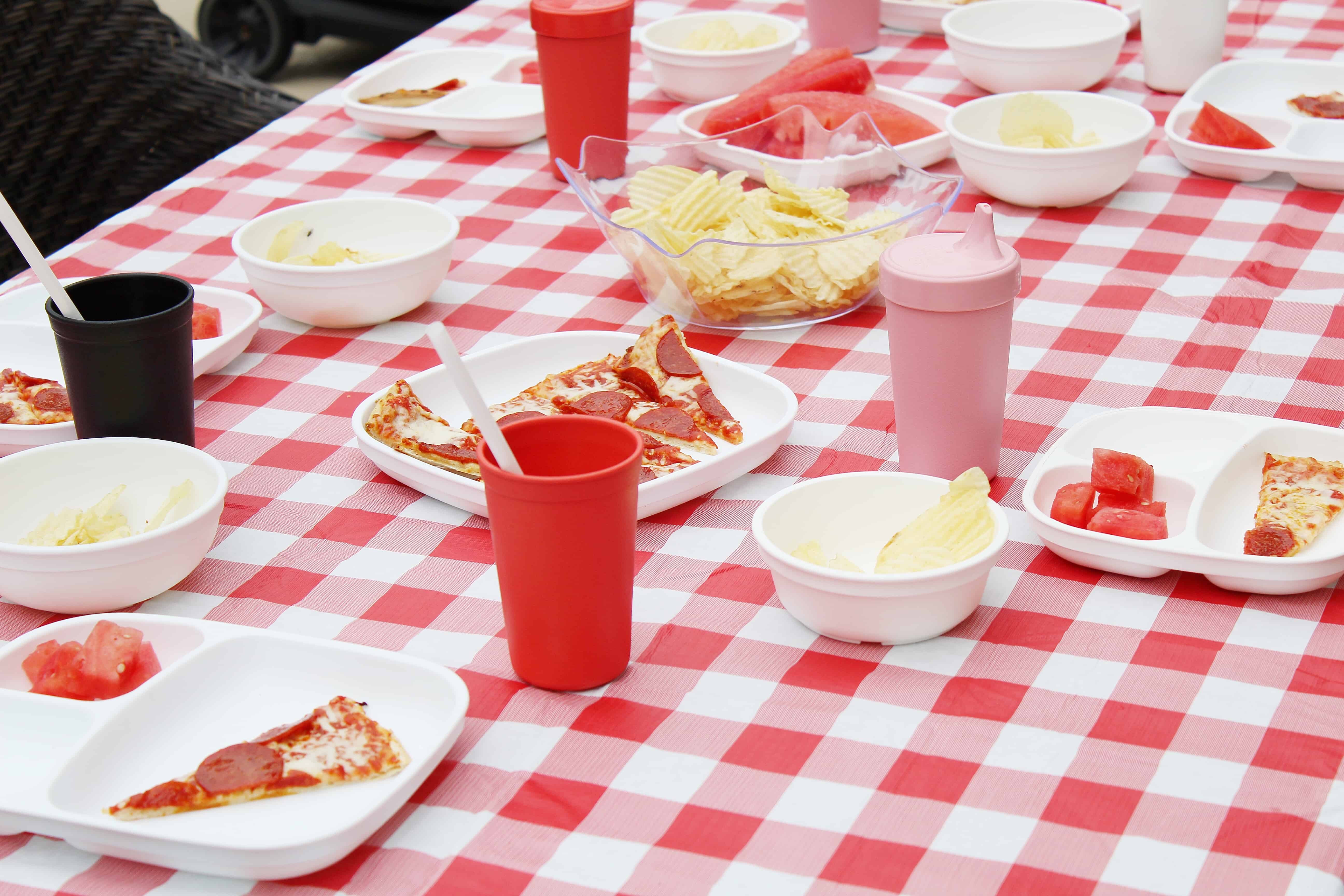 red and white table cloth with plates and cups