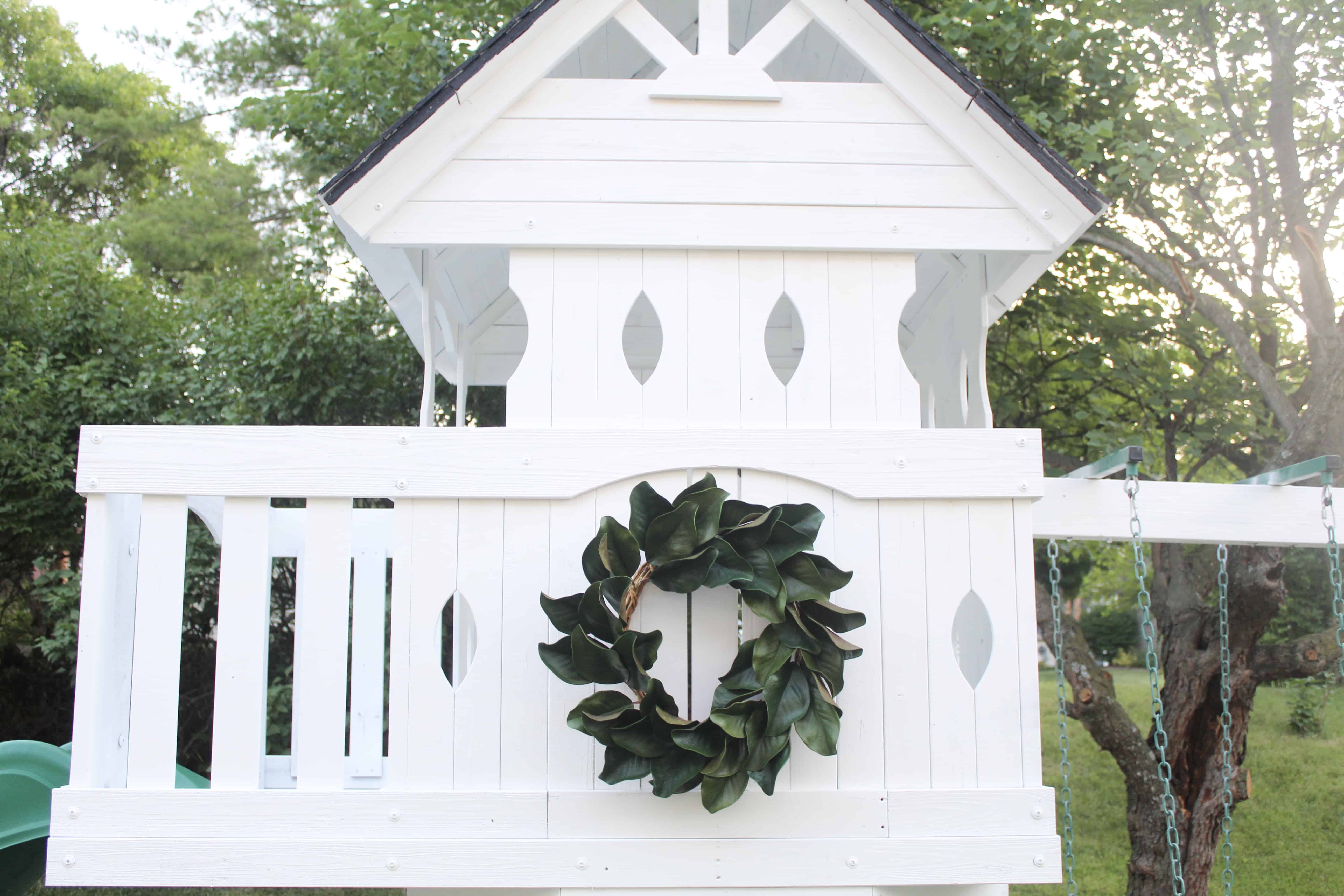 White swingset with magnolia wreath | DIY Swingset Makeover 