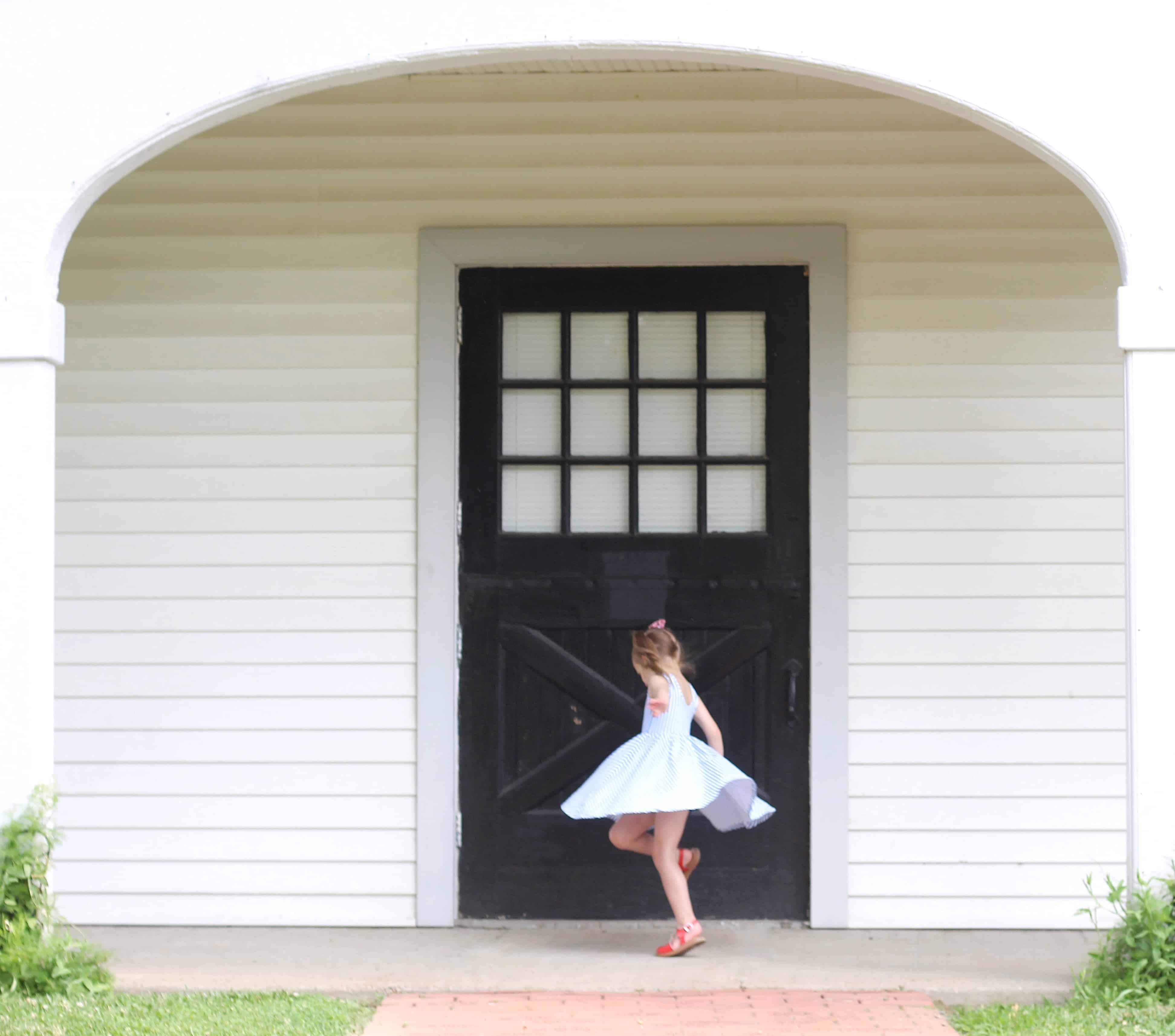 little girl twirling in Alice and Ames dress