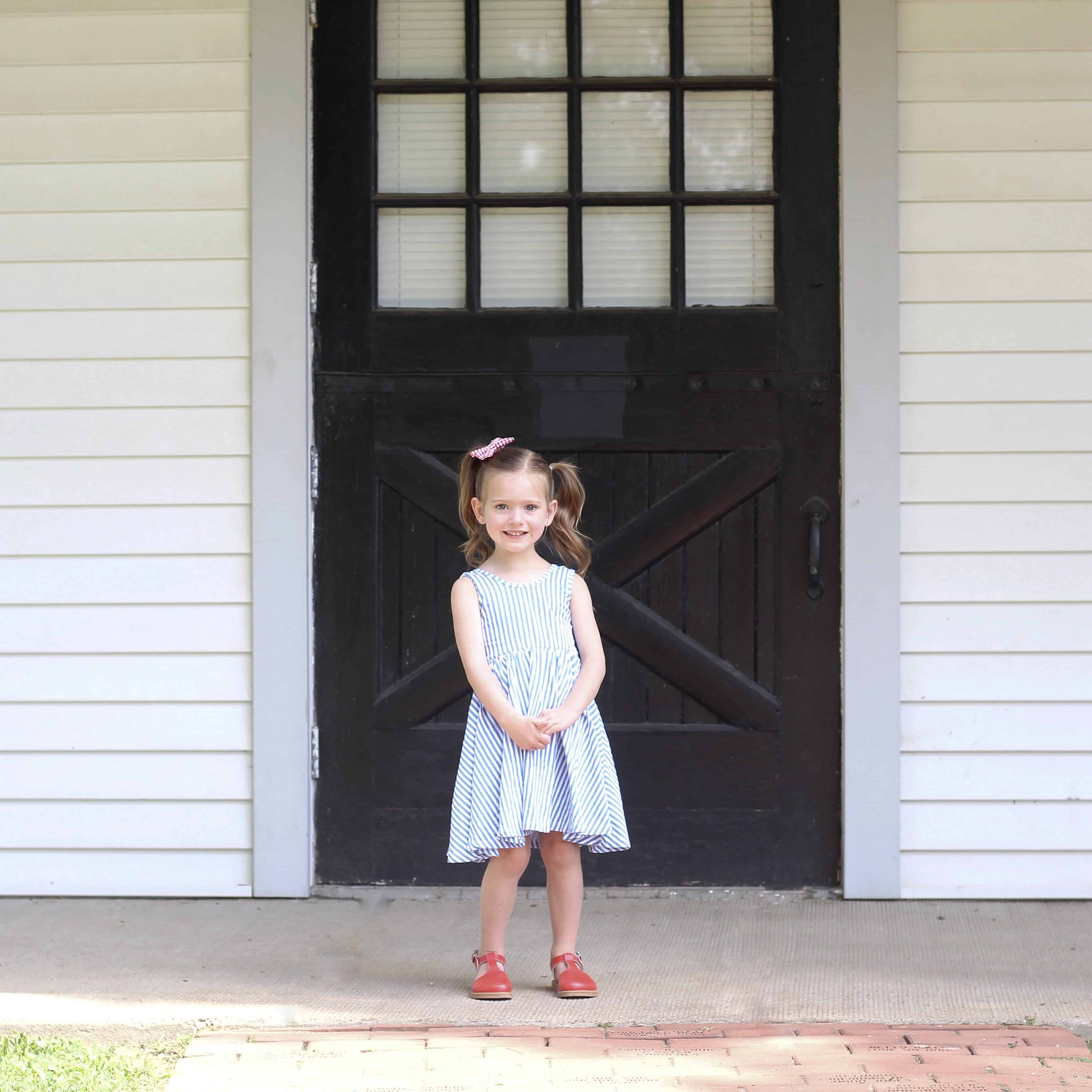 little girl in blue stripe Alice and ames dress