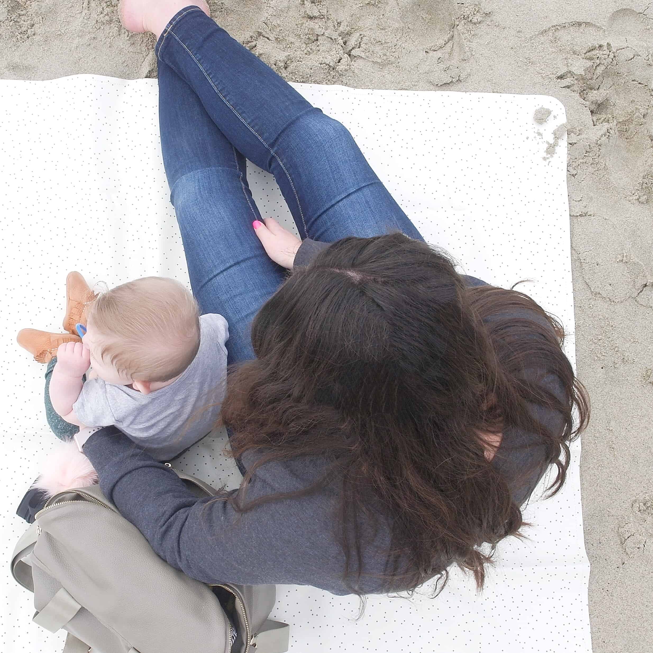 baby and mom on gathre mat at beach | Baby and Toddler Beach Must Haves