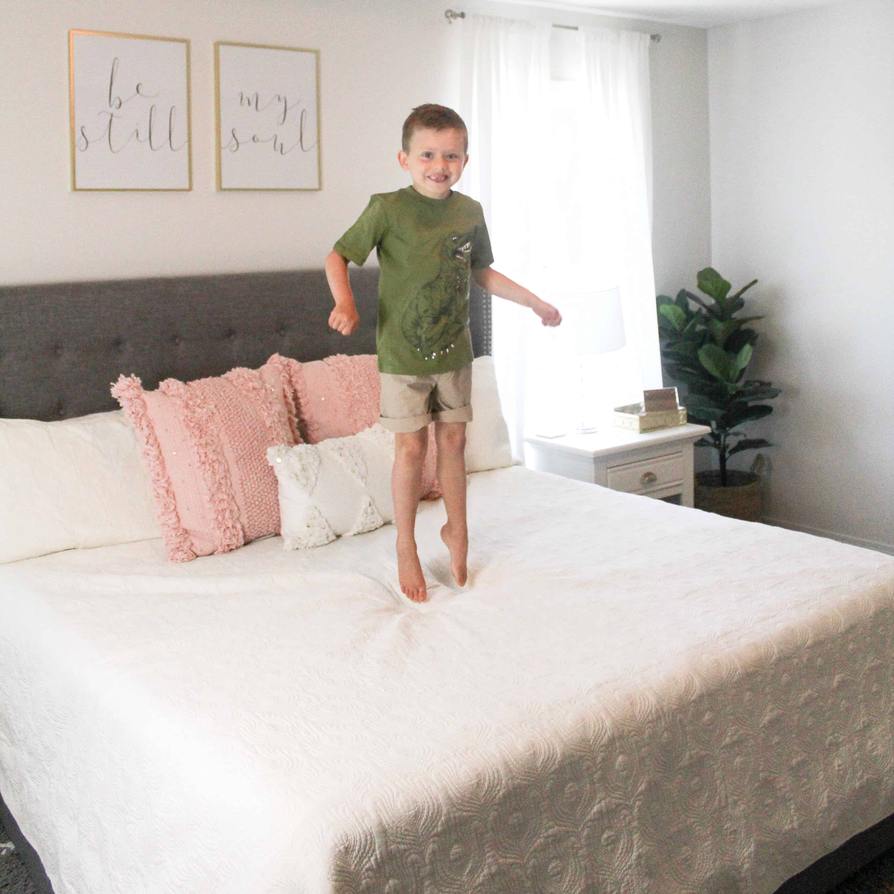 Little boy jumping on bed in Carter's Clothes