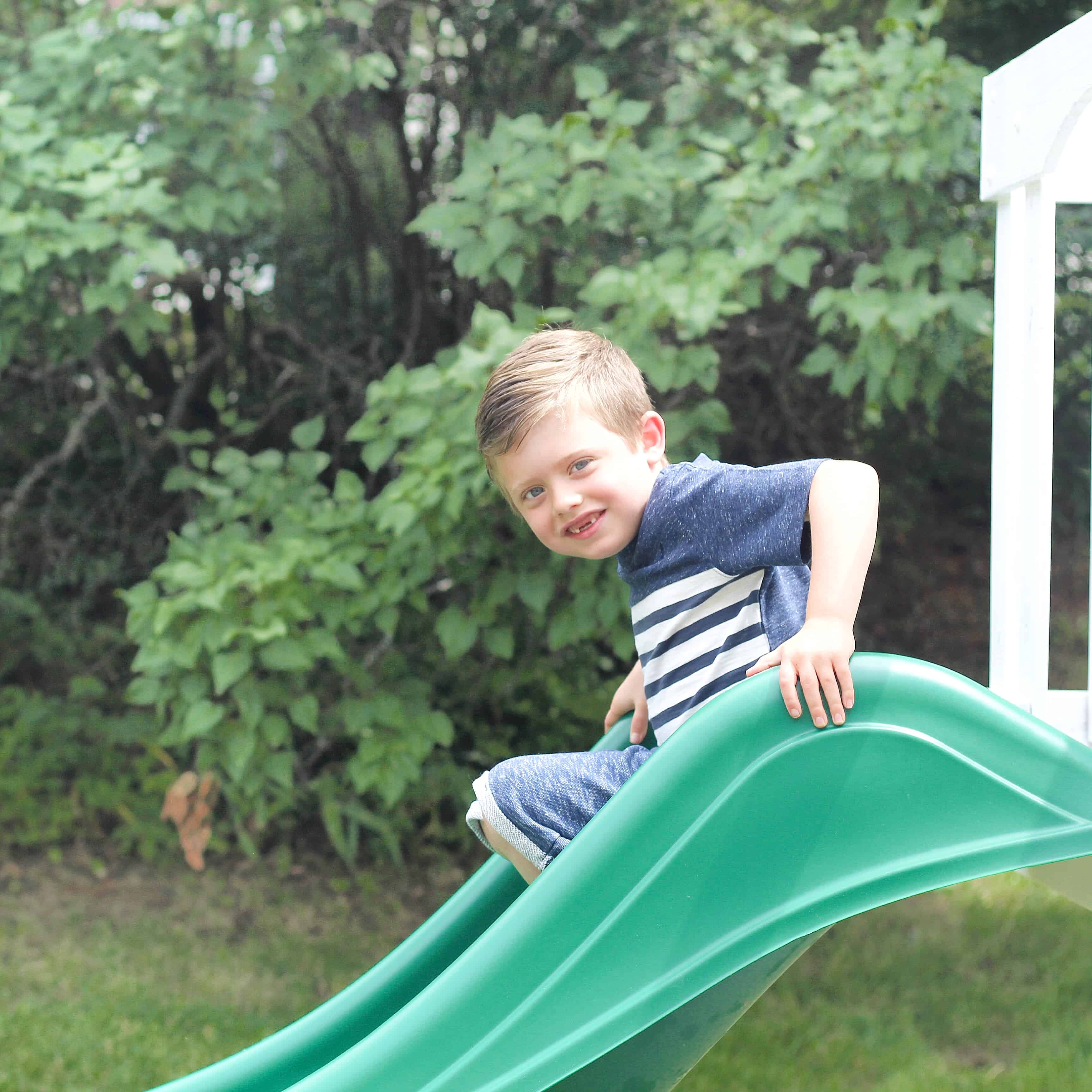 little boy going down the slide