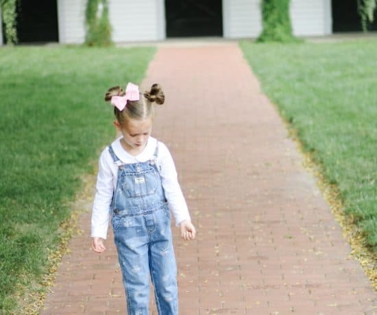toddler girl in OshKosh overalls