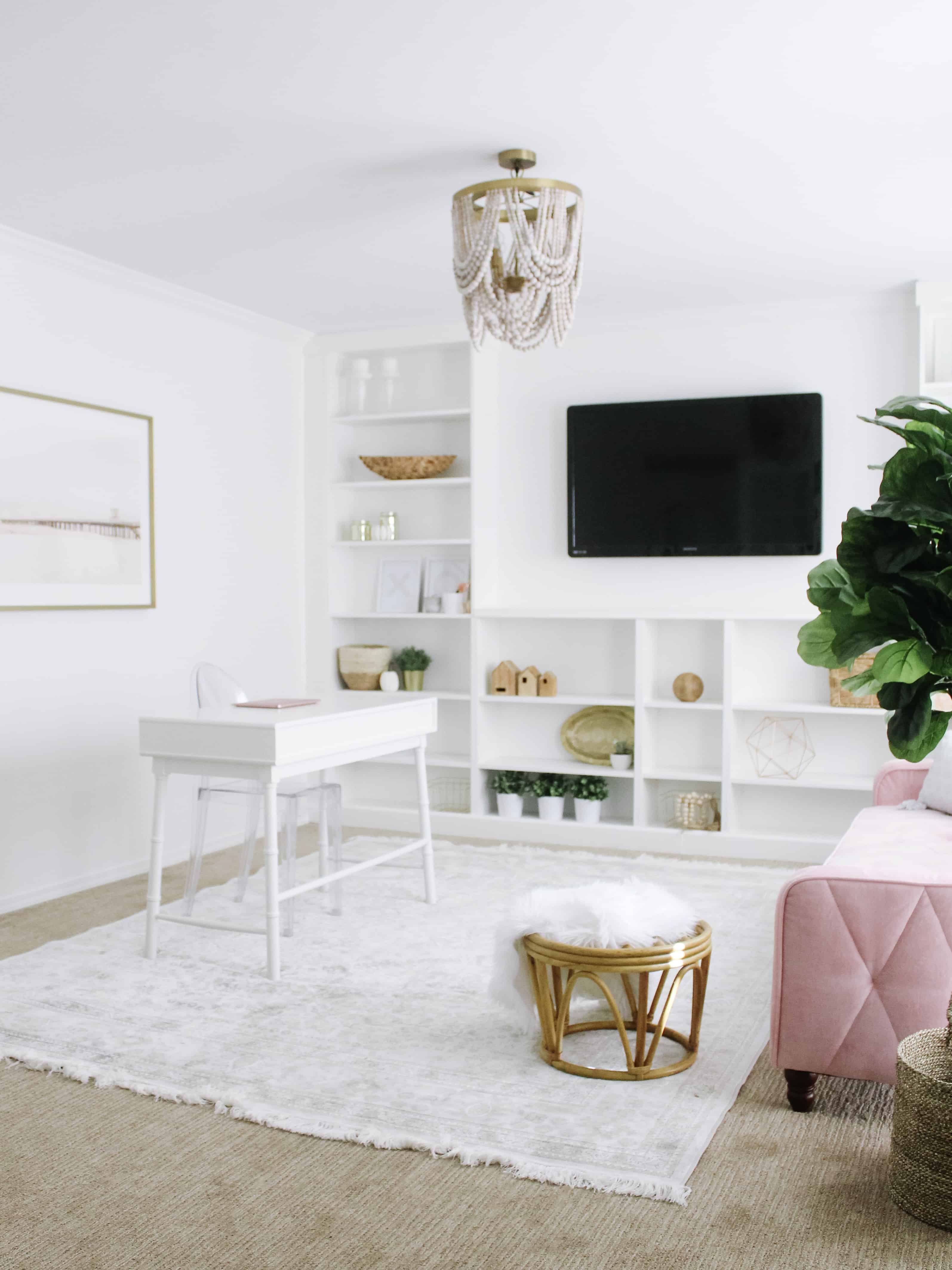bright white home office with pink couch