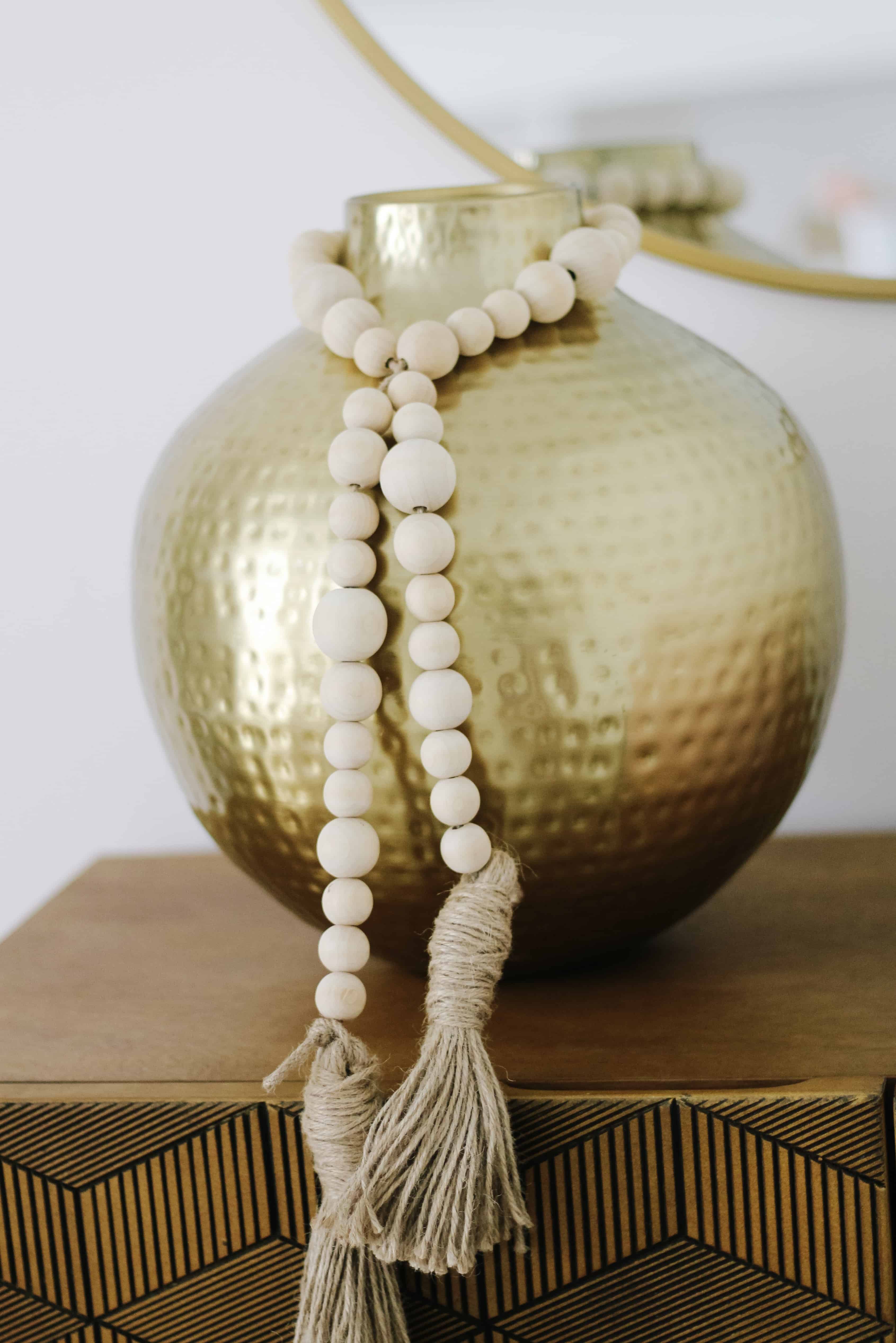 wood beads on gold vase