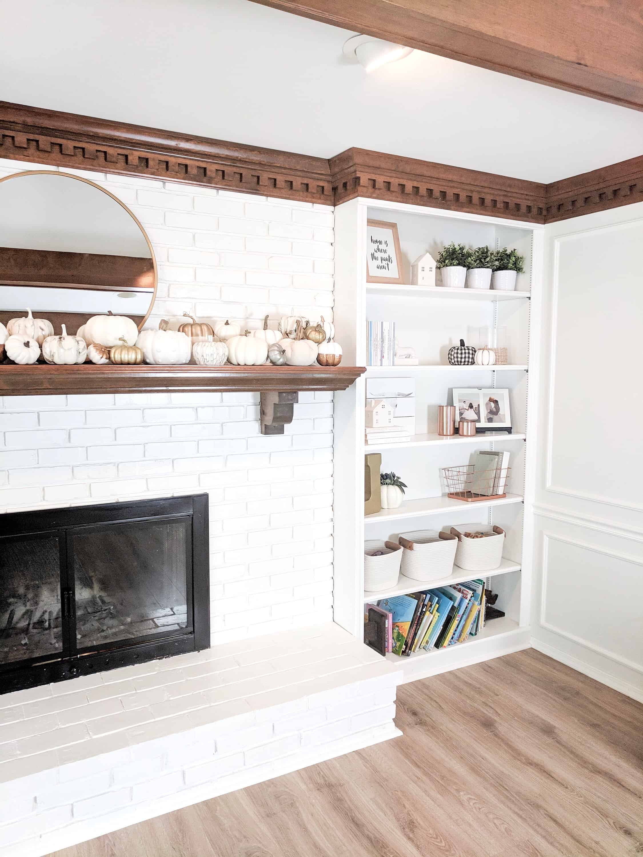 built-ins and white brick fireplace
