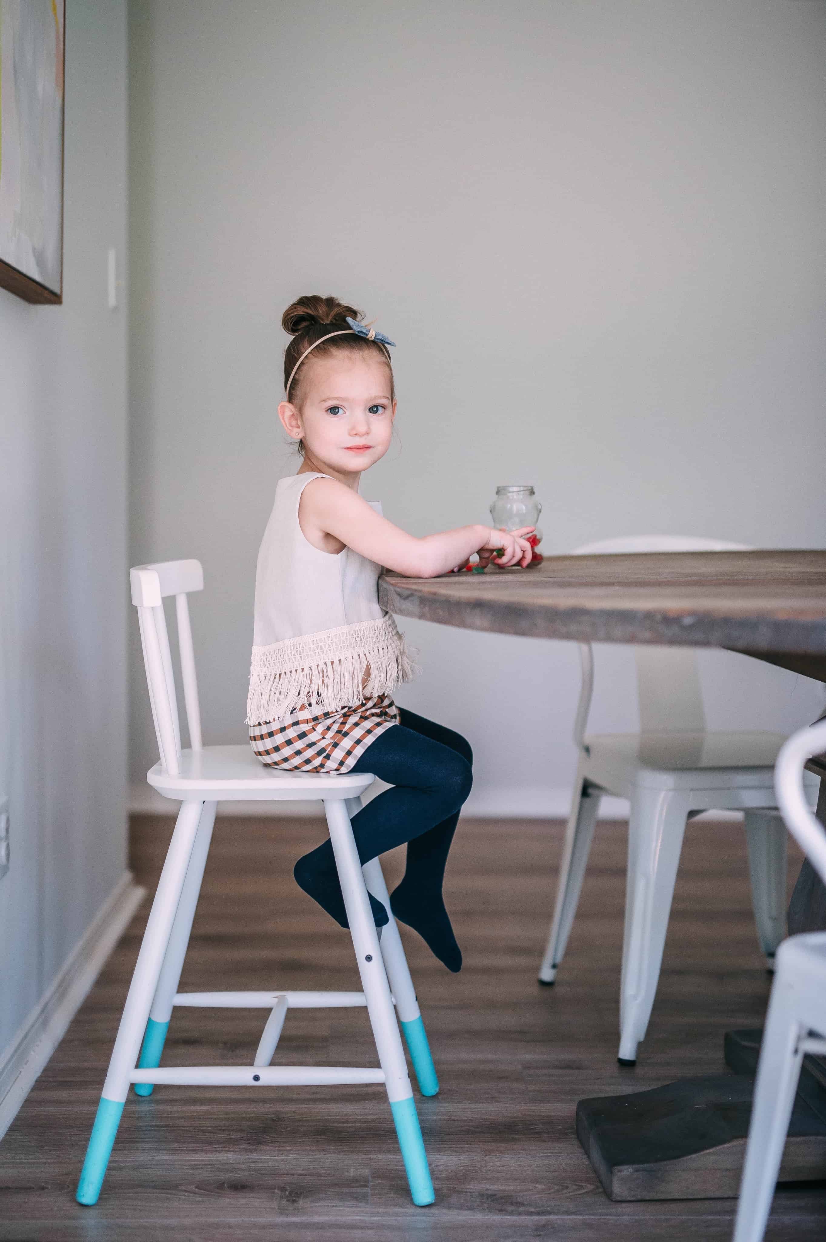 toddler girl sitting at table