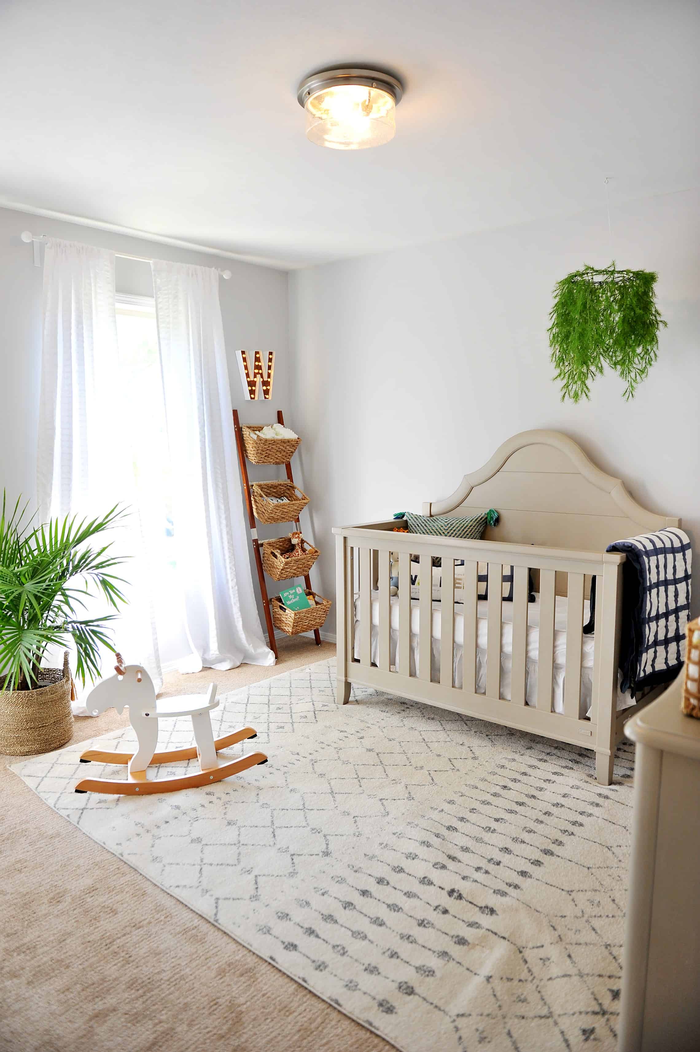 nursery with grey walls and green and navy pops