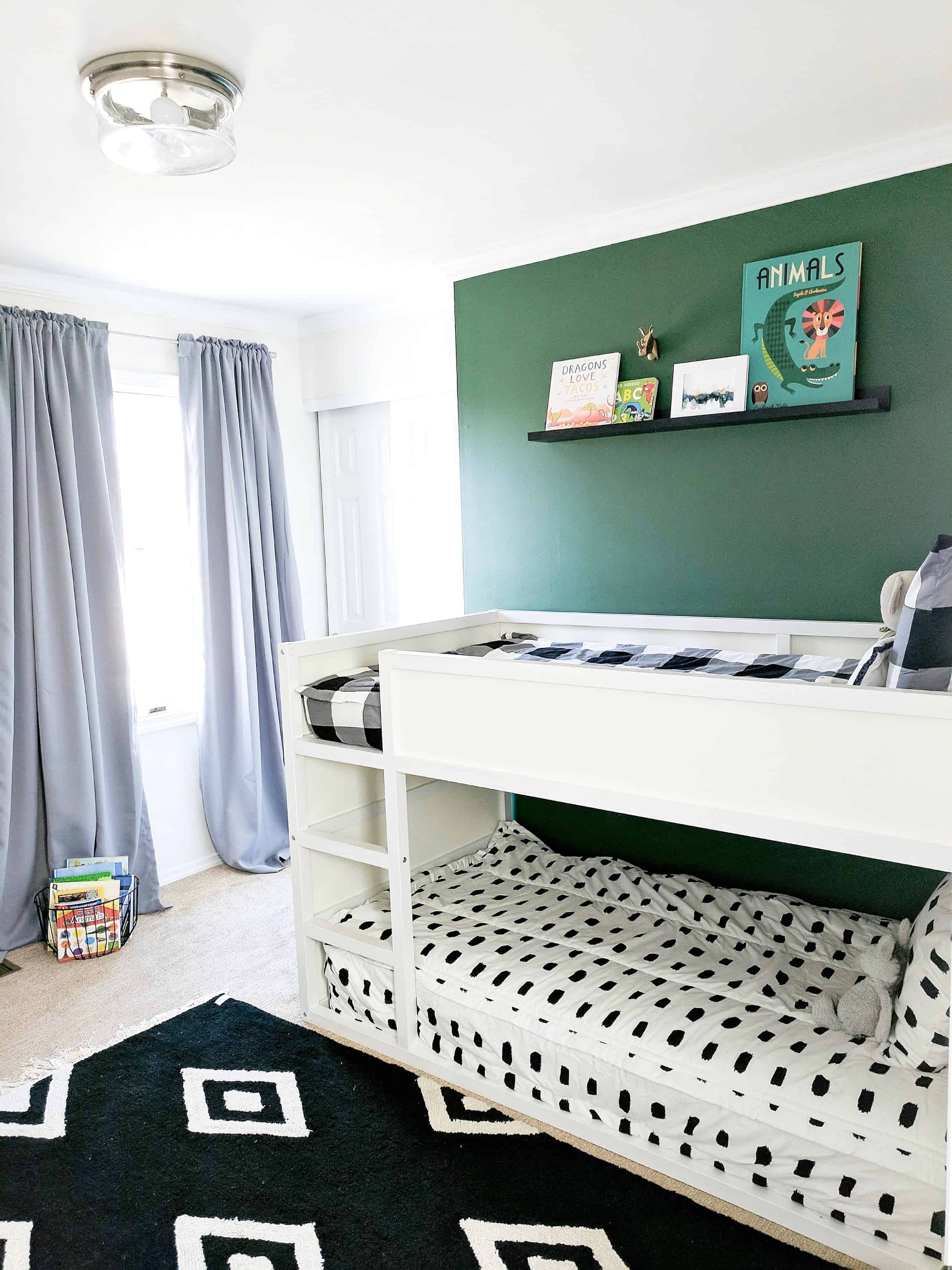 Green wall behind white bunk beds