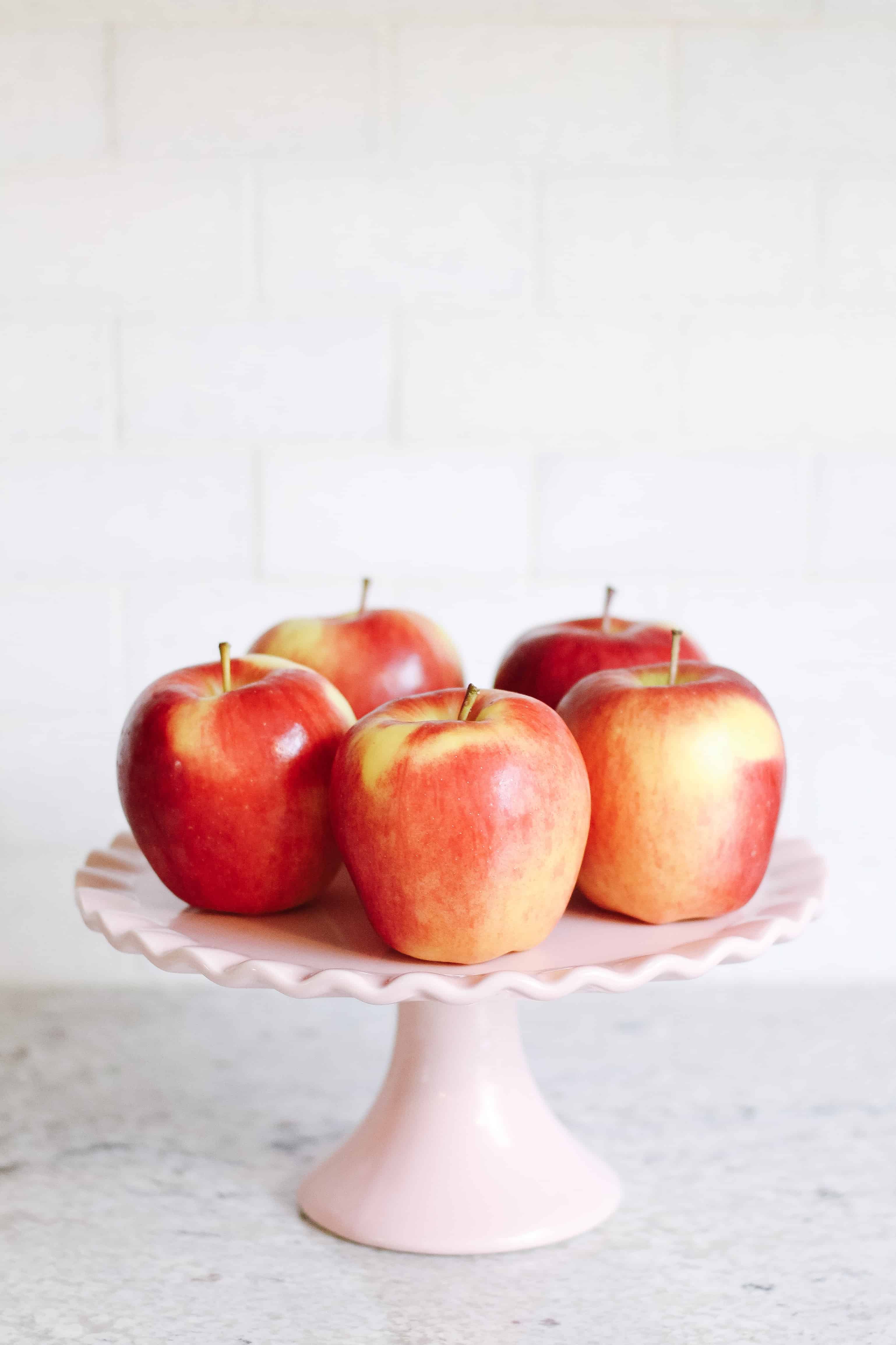 Apples on pink cake stand