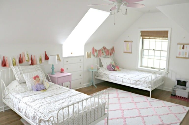 two white Ikea twin beds in a little girl bedroom