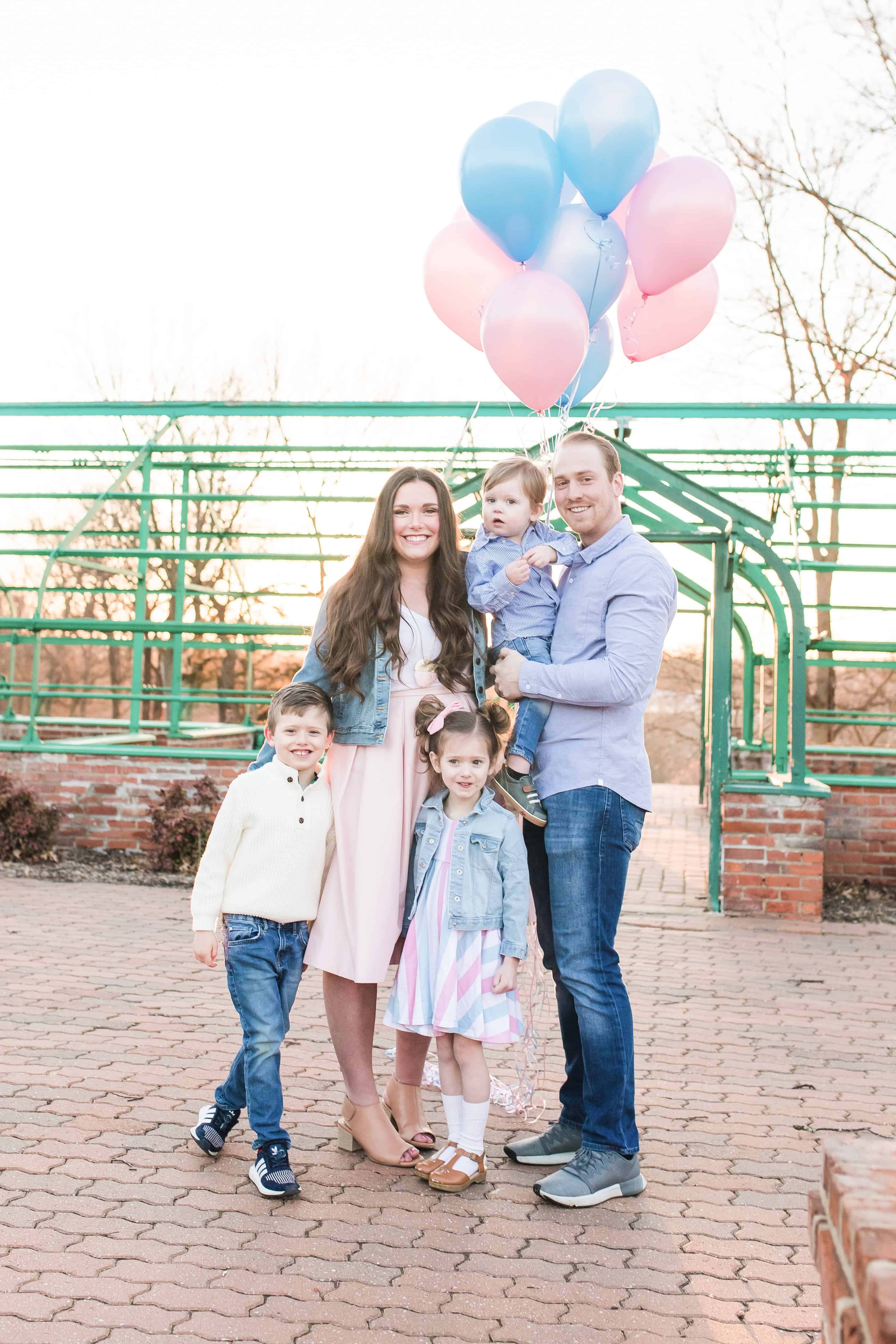 Family of 5 with pink and blue balloons