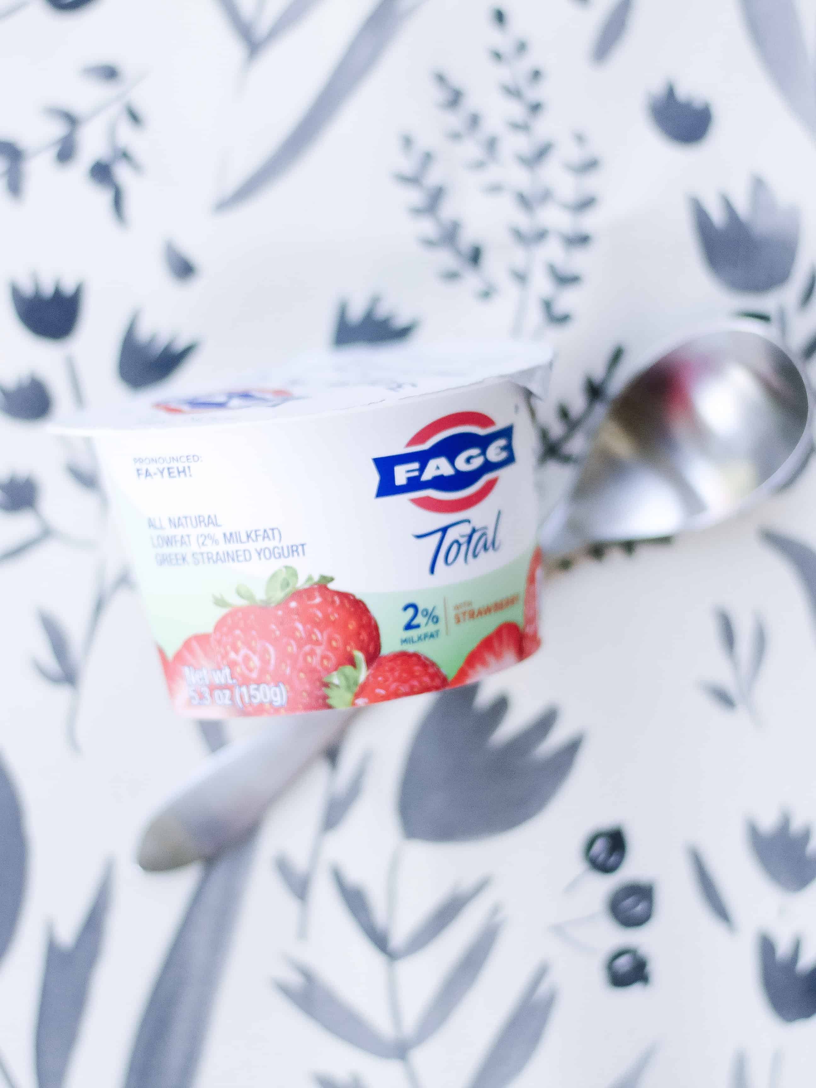 Fage Yogurt with spoon on gathre mat