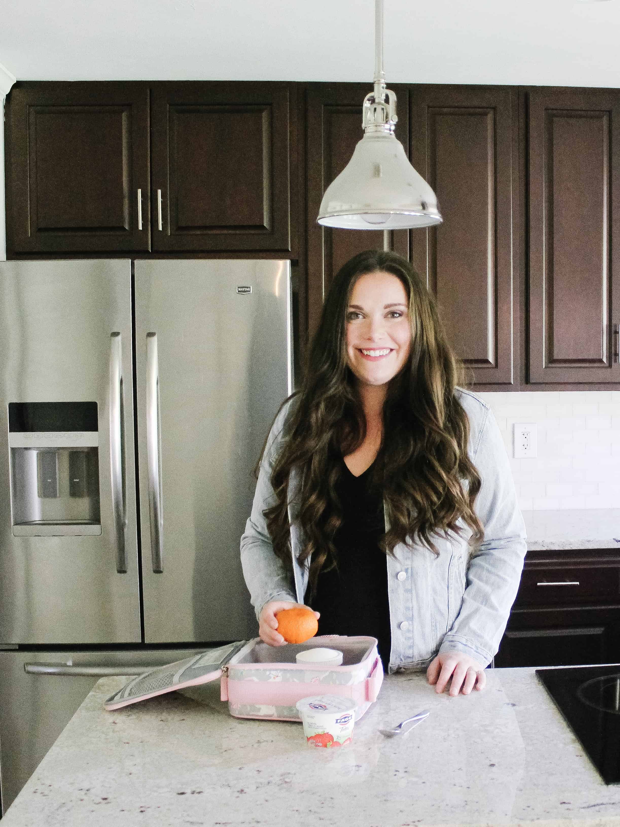 woman packing lunches in kitchen