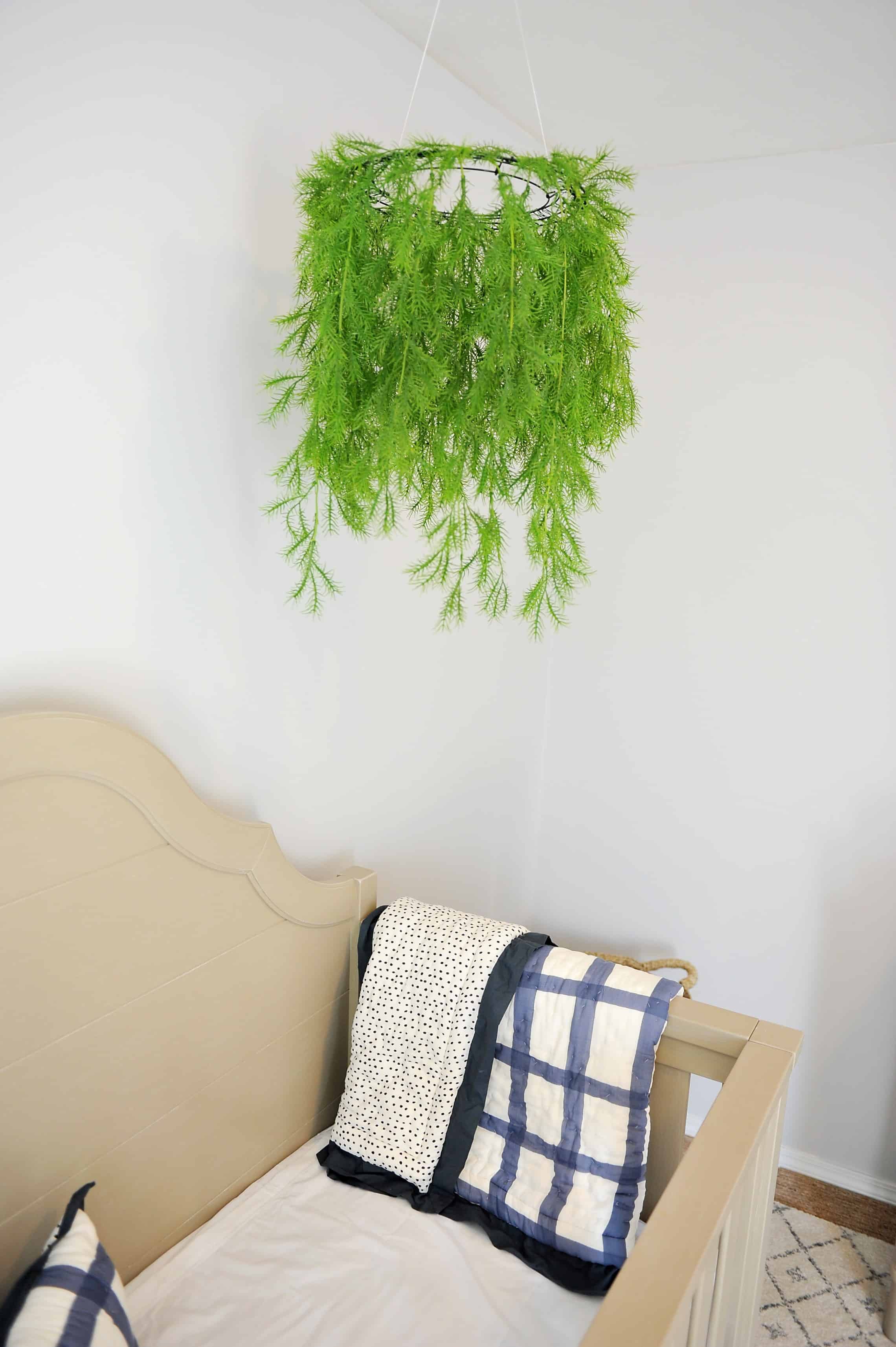 Greenery mobile hanging over crib