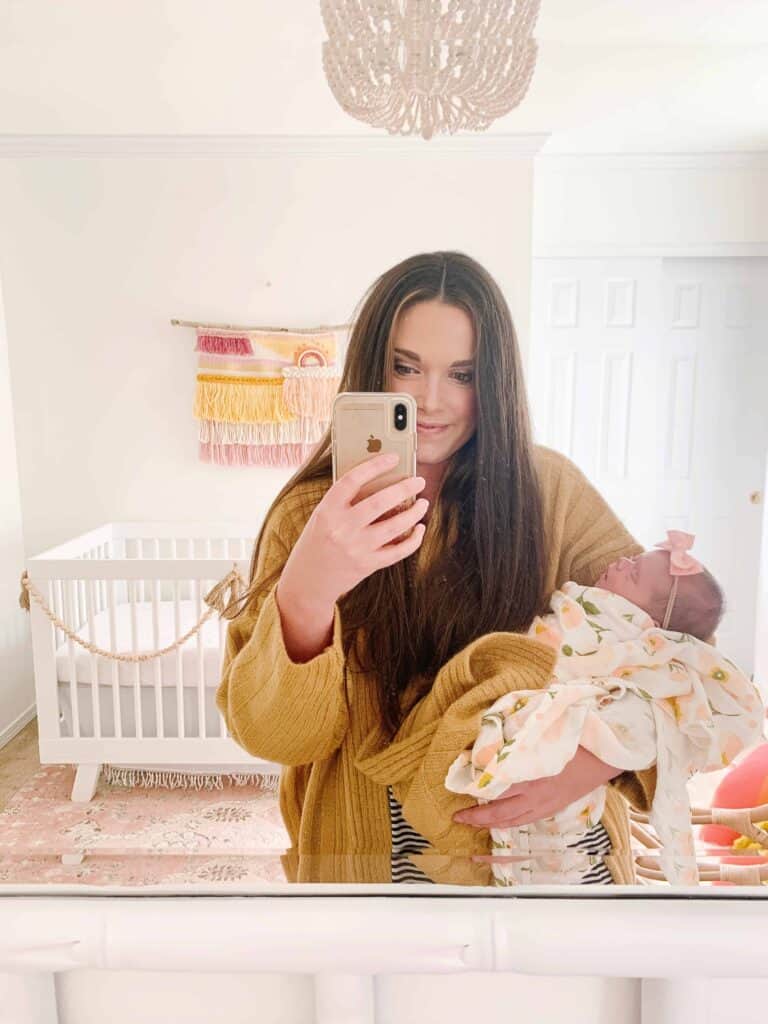 mom and baby girl in Nursery