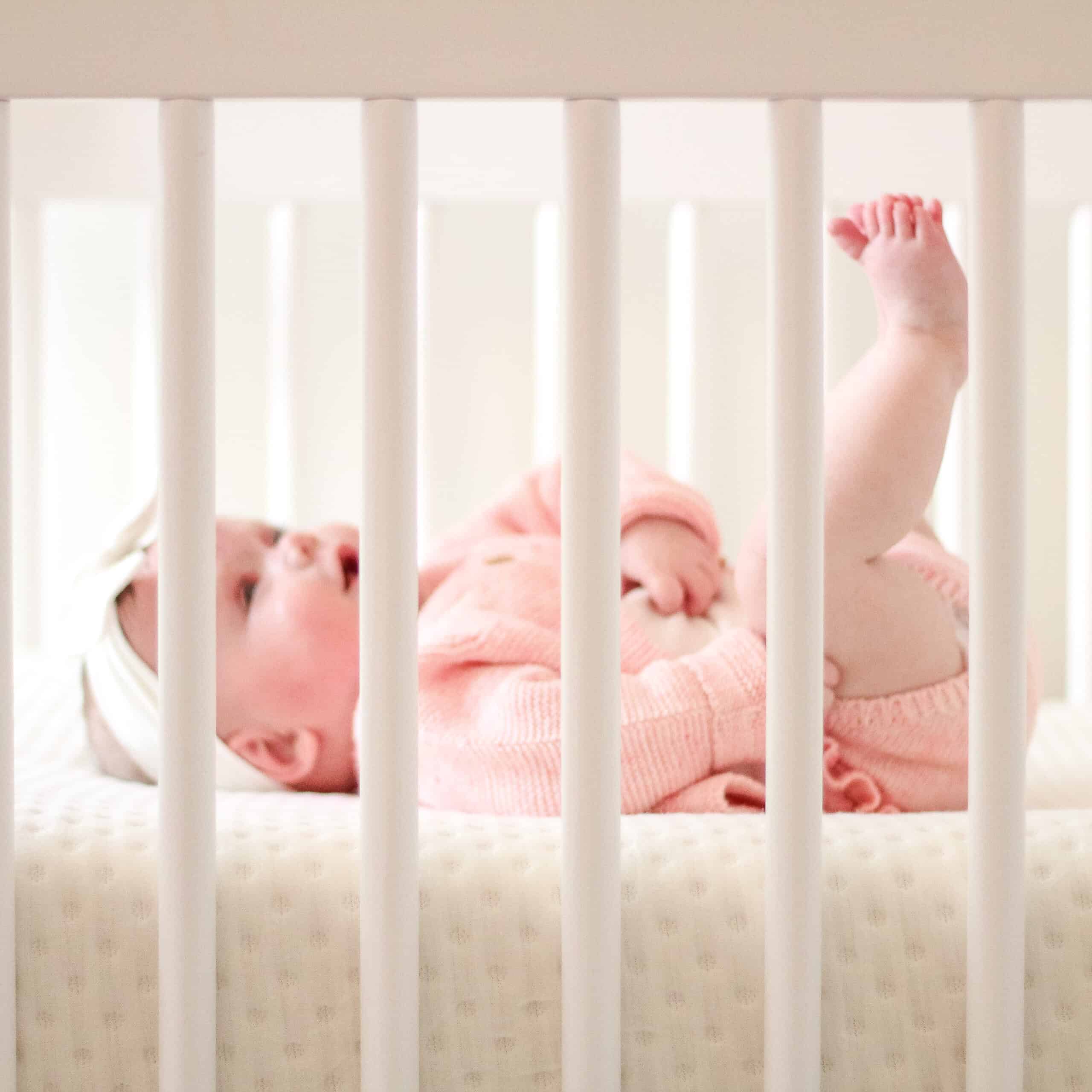 Baby girl on nook mattress