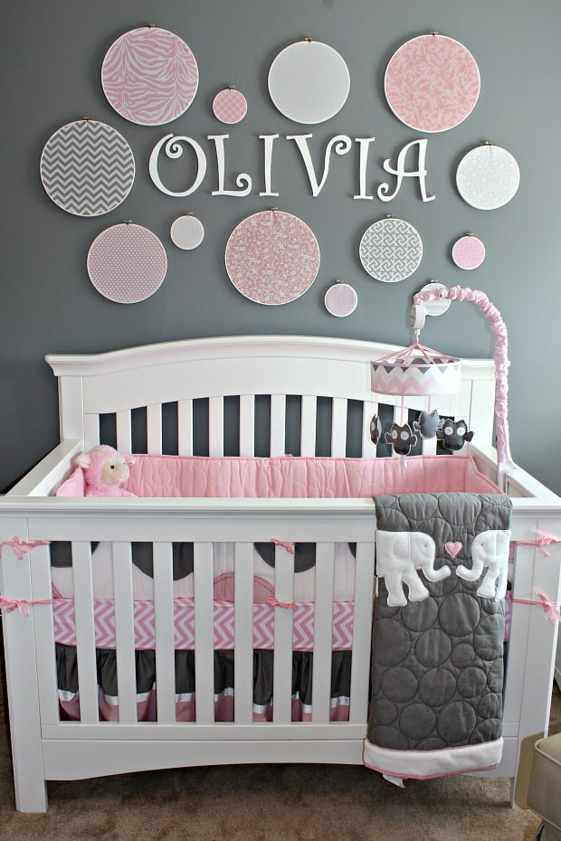 Grey Nursery with embroidery hoop wall and name over crib