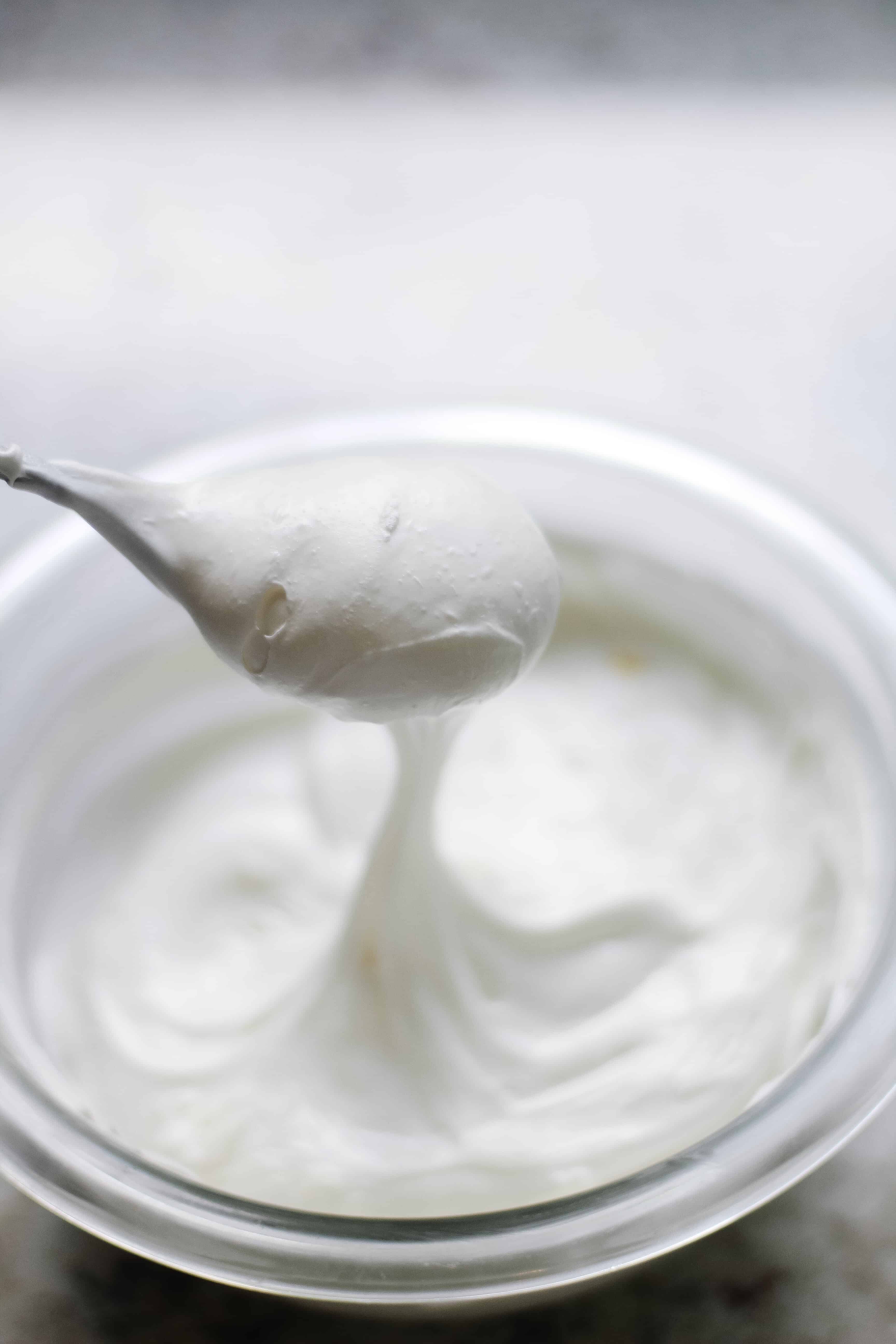 bowl of icing with a spoon in it